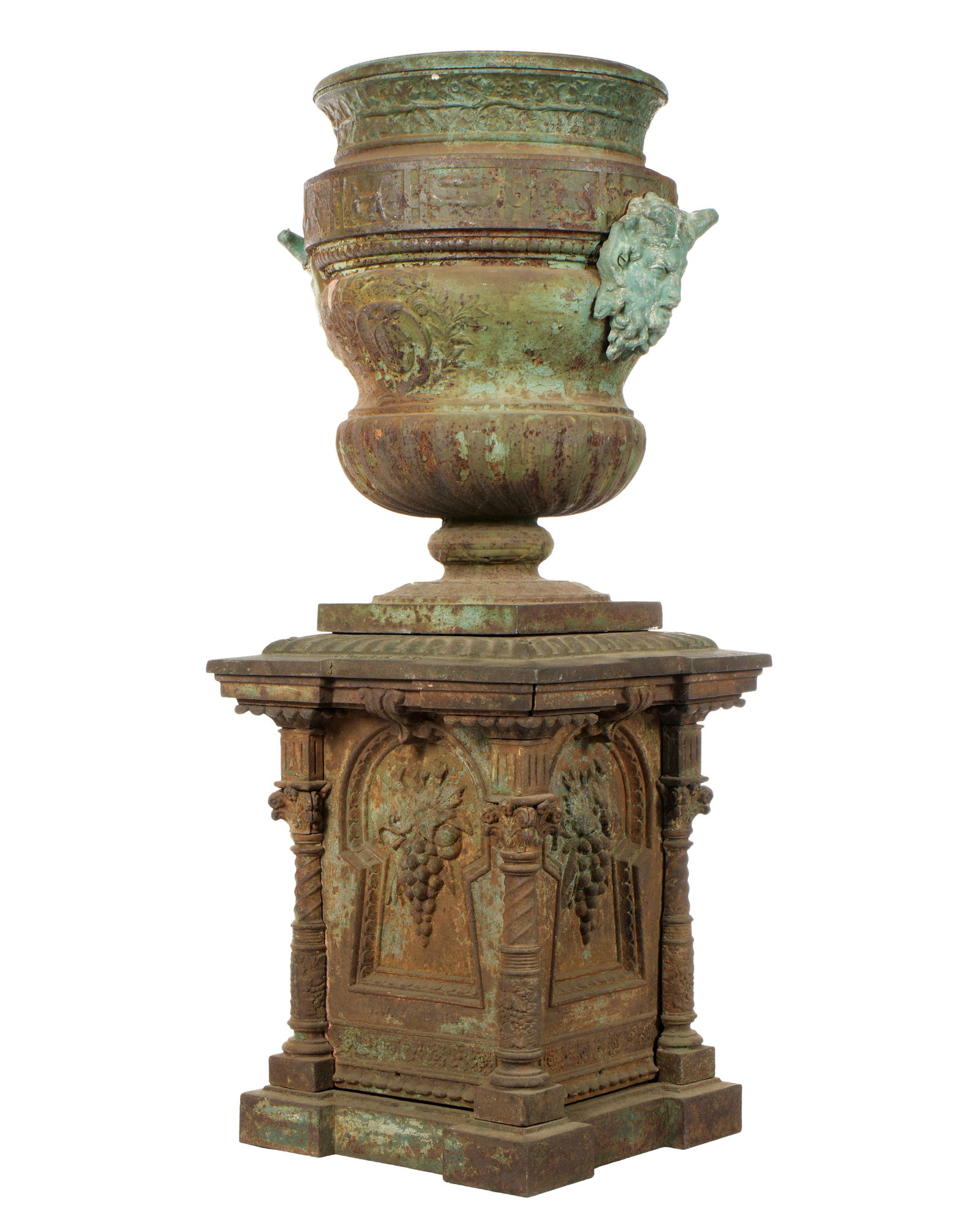 J. W. Fiske Cast Iron Garden Pedestal with Urn: Classical motif base with fruiting grape vine panels, ornate corner columns, signed J. W. Fiske, NY. Bacchanalian motif large urn above with satyr mask handles, unmarked. Base measures 25.75" h. x 20.