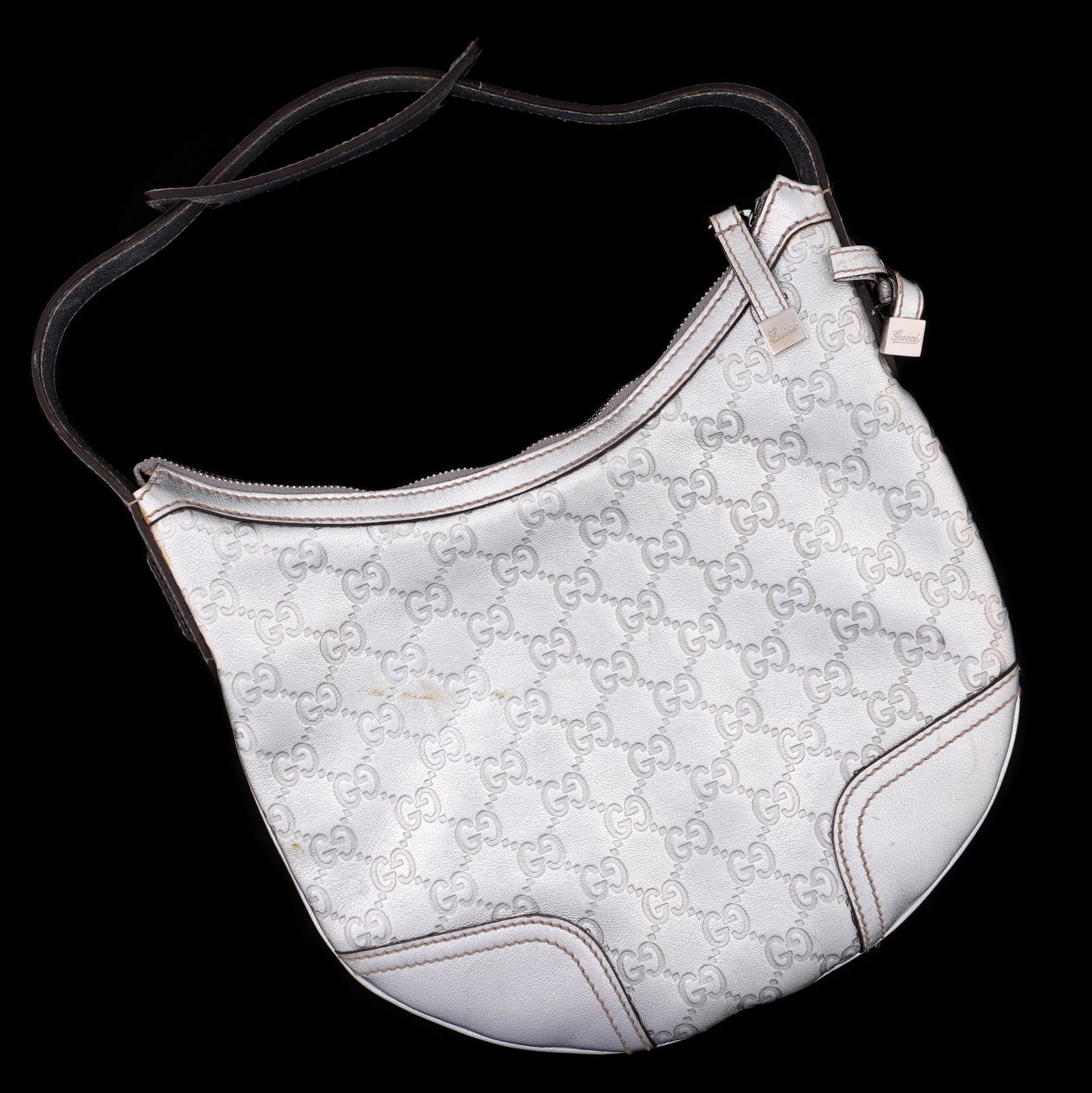 Gucci Guccissima Princy Silver Leather Hobo Bag: "Guccissima Princy" silver metallic leather hobo bag by Gucci. Silver leather strap, printed canvas interior with pocket. 25cm h. x 25cm x 3.5cm (10" x 10" x 1.5") excluding strap. Condition: Minor si