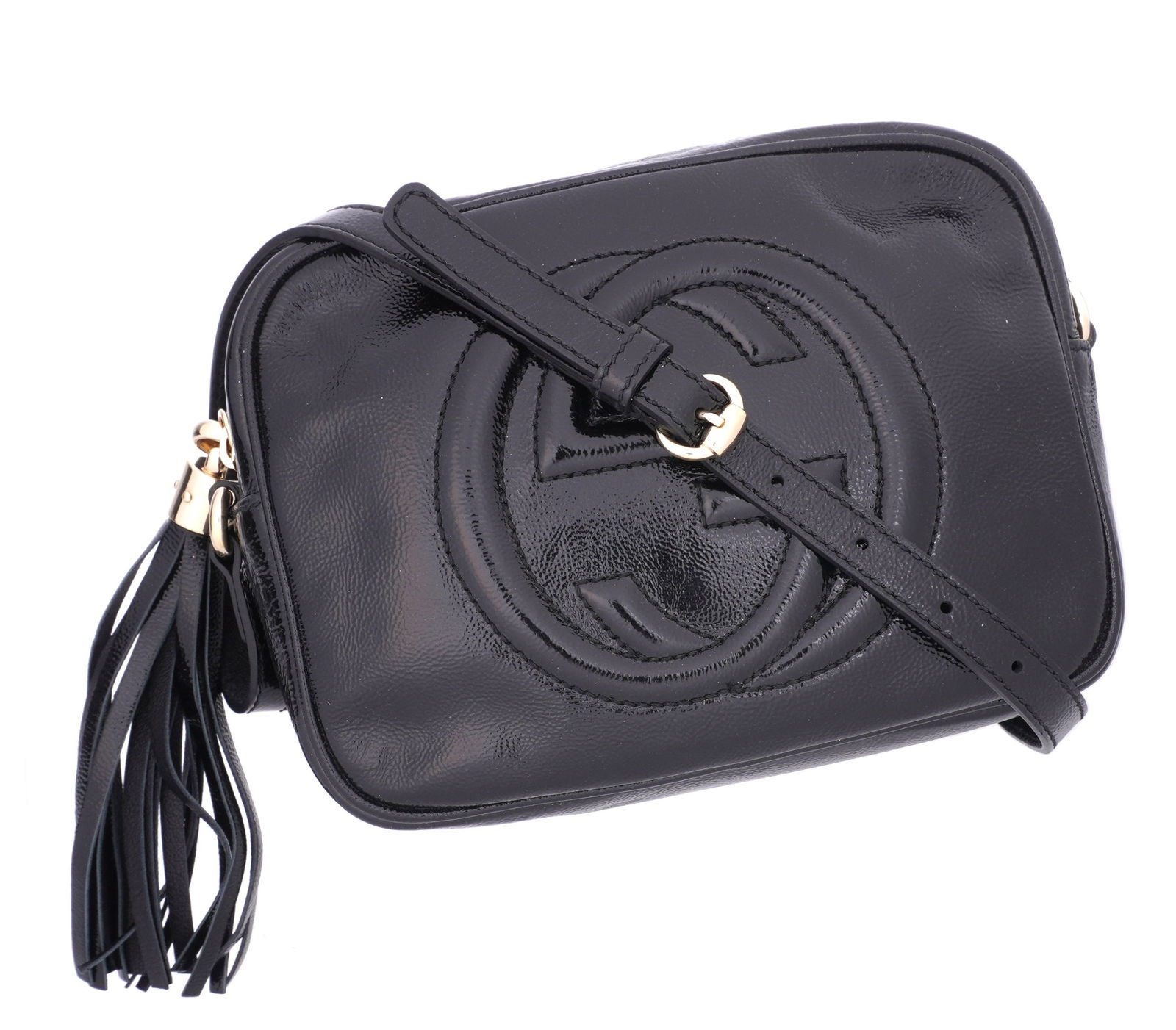 Gucci Soho Disco Black Leather Crossbody Bag: Black patent leather "Soho Disco" crossbody bag / purse. Gold toned accents and black patent leather tassel. Numbered B016968238. 6.75" h .x 8.75" x 3". Condition: Extremely minor if any signs of wear