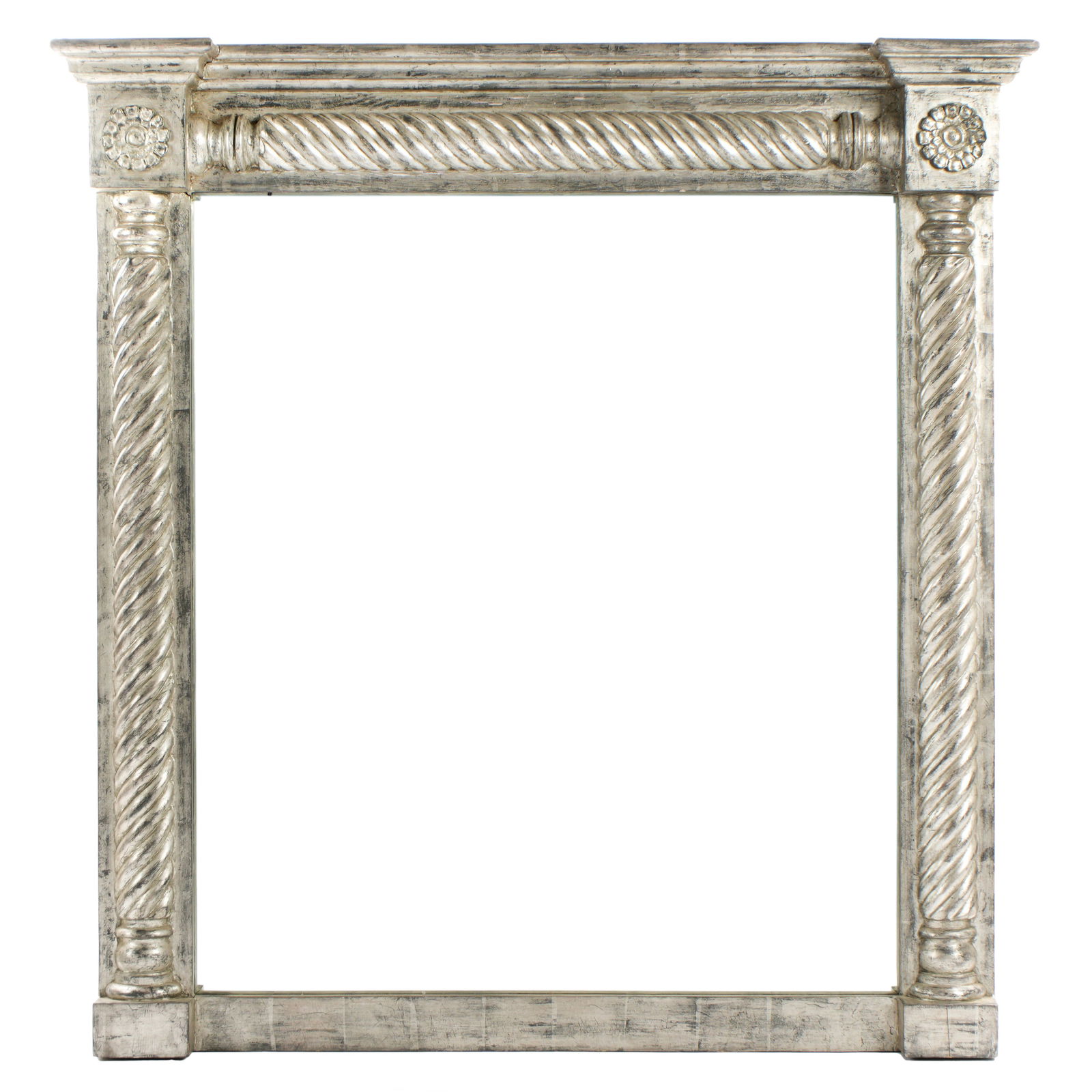 Carved Silver Gilt Wood Over Mantle Mirror: Classical carved distressed silver gilt frame, molded cornice over barley twist columns, medallions at top joints. Overall 48.75" h. x 43.5" x 5". Condition: Wear to gilt finish.