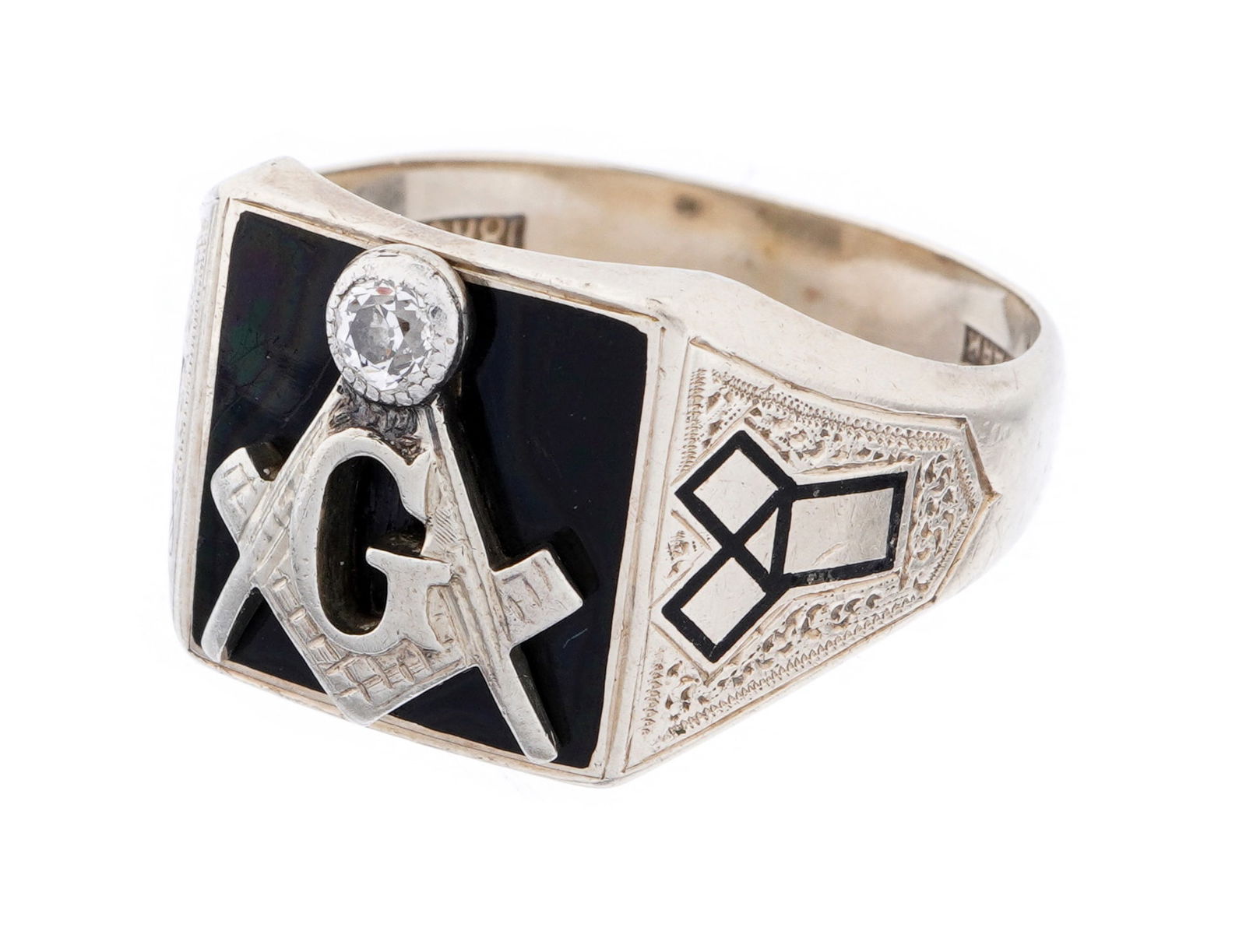 18k on 14k Gold Masonic Onyx & Diamond Ring: 18k on 14k white gold diamond ring, center inset black onyx with applied square and compass with round approx, .15ct diamond. Engraved Masonic emblems either side. Marked 18k on 14k and Trademark. Siz
