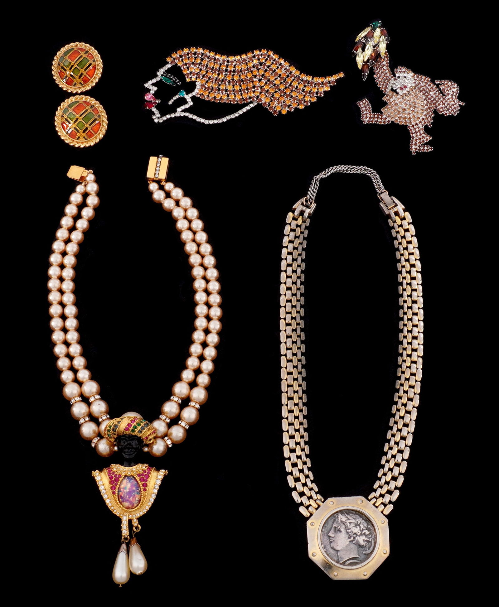Five Piece Butler & Wilson Costume Jewelry: An assembled collection five pieces to include 1) Faux pearl necklace with Orientalist bust pendant 15" long. 2) Toned metal metal necklace with faux Roman coin medallion, 18" long. Note wear to finis