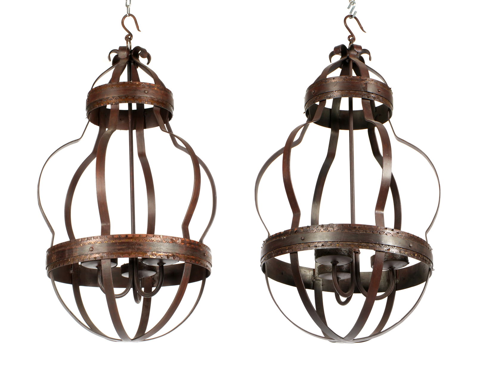 Pair Gothic Revival Style Wrought Iron Chandeliers: Each with wrought iron frame with six serpentine form support bands, three candle stands inside. Overall 29.5" h. x 15.5".