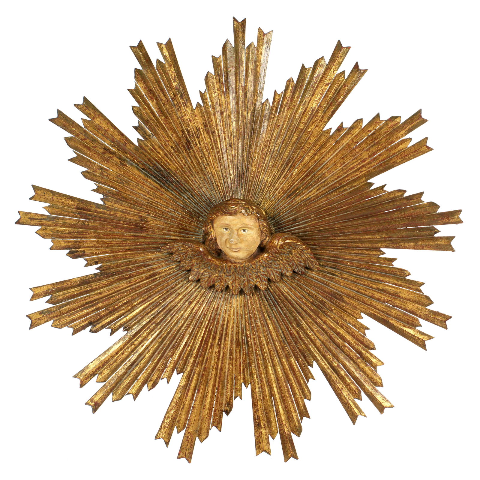 Italian Carved Giltwood Cherub Sunburst Panel: 19th Century, center carved figural winged cherub masqueron, gilt wood carved sunburst rays radiating out from center. Back painted red, unmarked. Overall 40" dia x 7" deep. Condition: Chips and wear