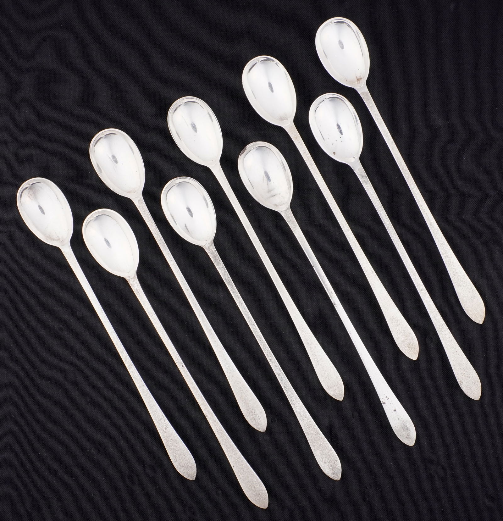 Nine Tiffany Faneuil Sterling Iced Tea Spoons: Nine sterling silver iced tea spoons (7.5" long) total in the Faneuil pattern by Tiffany & Co.. Approx. 366 grams. Condition: Scratches and signs of wear.