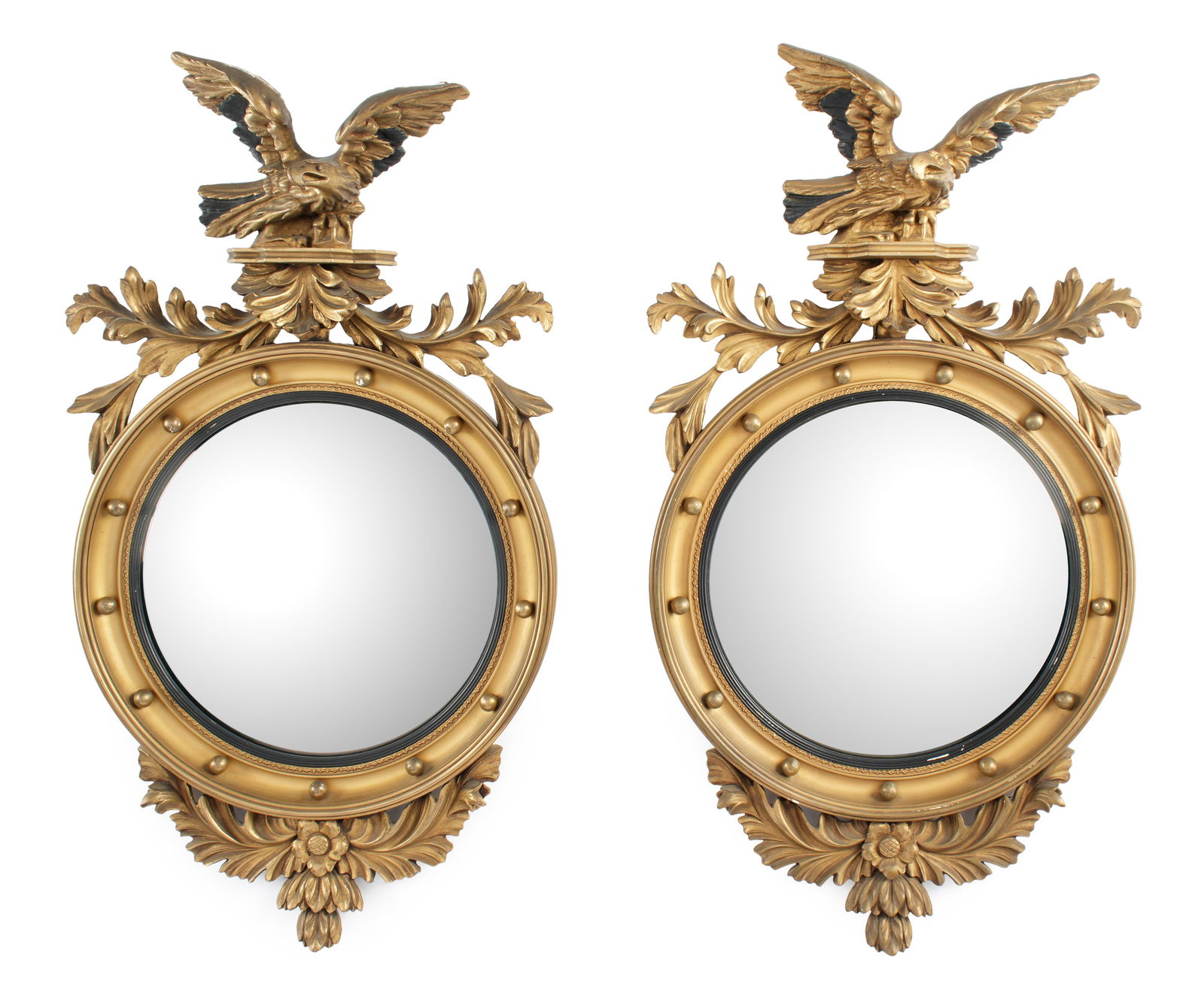 Pair Federal Style Eagle Bullseye Convex Mirrors: Circa 1910, carved gilt and ebonized wood frames. Spread wing eagle of foliate spray, round body, lower foliate accents. Overall 36" h .x 21" x 5.5". Condition: Minor age cracks and chips.