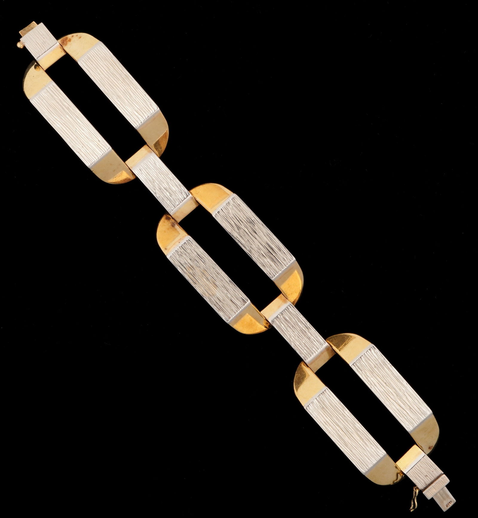 Vintage 14k Gold Mid Century Cuff Bracelet: 14k yellow and brushed white gold bracelet with three large interlocking links. Marked on clasp, 7.25" long. Approx. 76 grams.