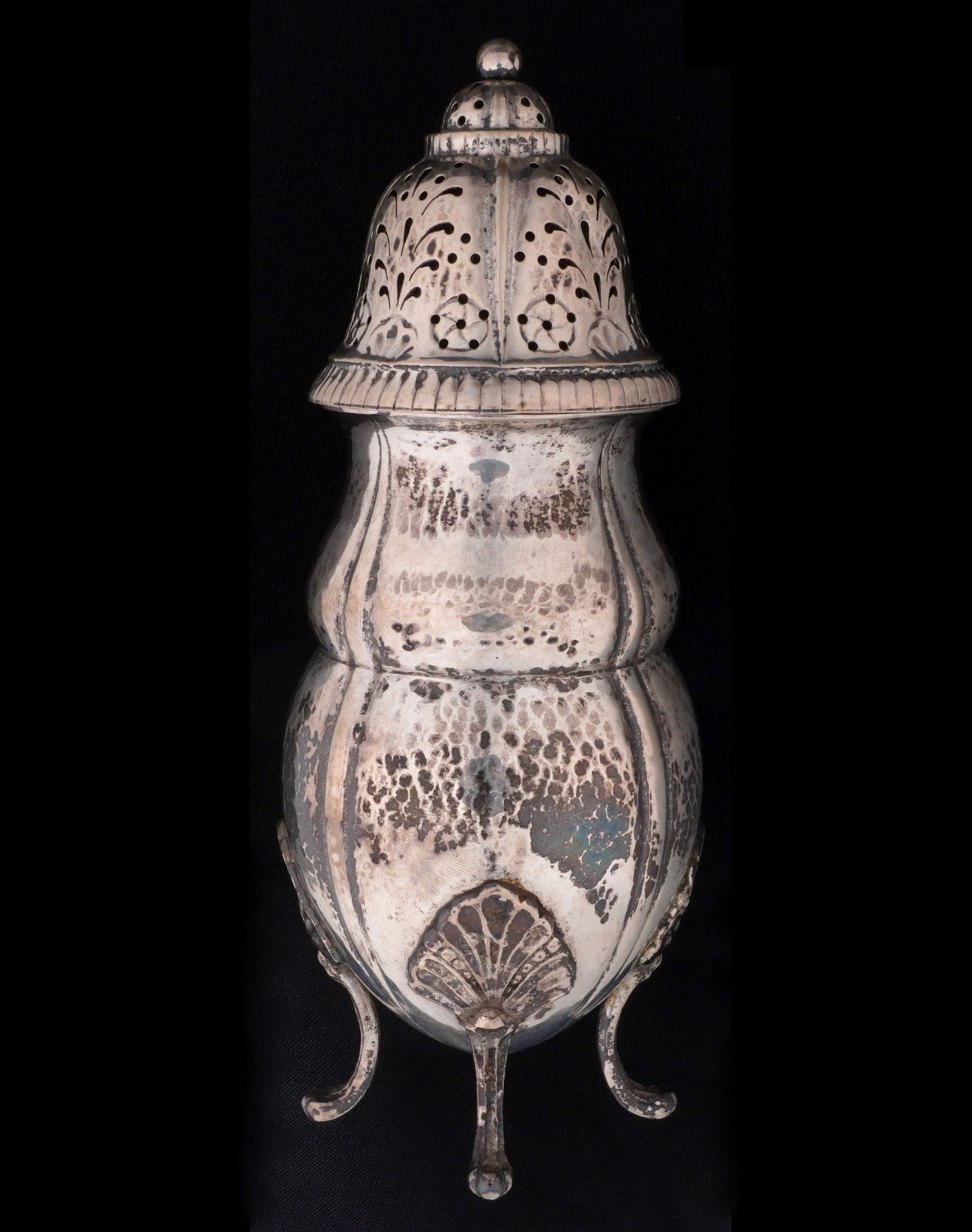 Danish Sterling Silver Hammered Muffineer: 1917 Danish sterling silver, reticulated top over hand hammered body, on four feet, hallmarked underneath. Overall 8.5" h. x 3". Approx. 268 grams. Condition: Minor dings and scratches.