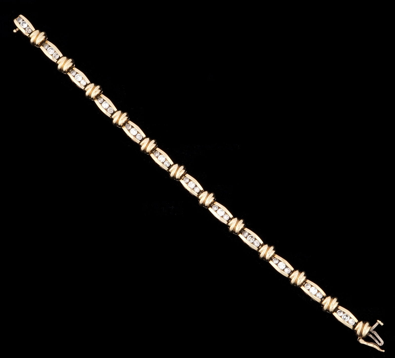 14k Gold and Diamond Tennis Bracelet: 14k yellow gold tennis bracelet, 36 channel set diamonds, approx. .85ctw, 7" long. Approx. 19.8 grams inclusive.