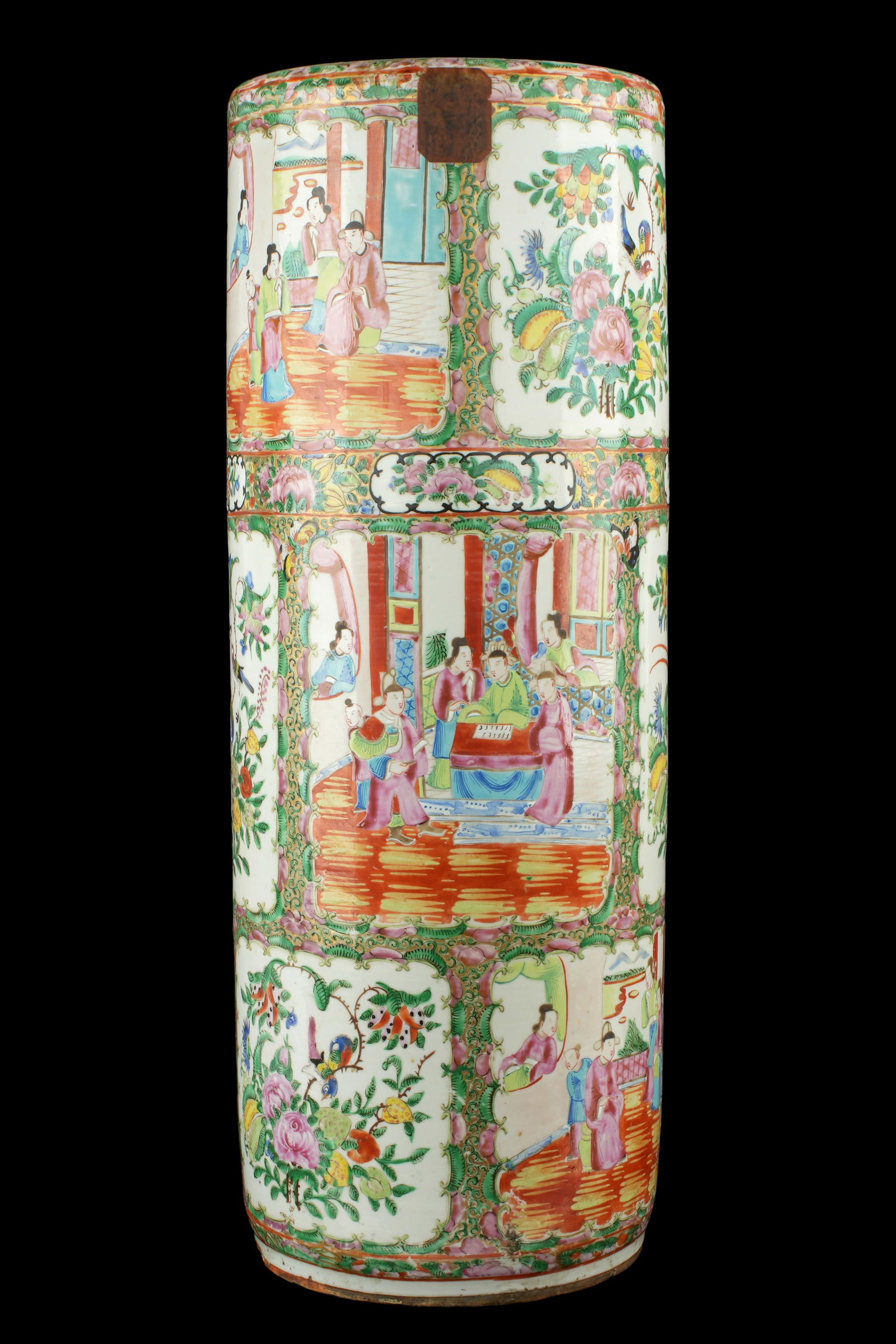 Antique Chinese Rose Medallion Umbrella Stand: White glaze porcelain ground, typical Rose Medallion motifs in panels, unmarked. Older partial paper label remains inside. Overall 24" h. x 9" dia. Condition: Cracks to base, minor wear to decoration.