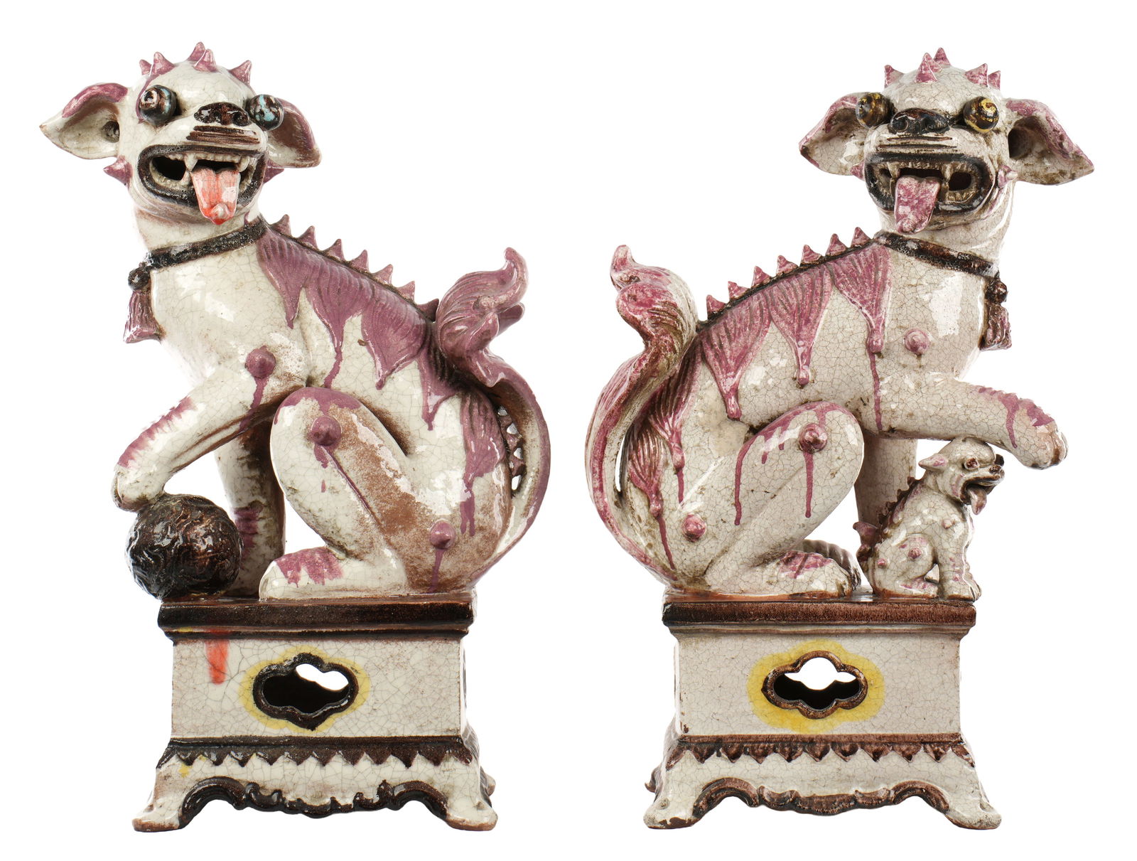 Pair Chinese Terracotta Figural Foo Dogs: Pair terracotta seated foo dogs on stands, white and rose pink crackle glaze, unmarked. Overall 25" h. x 16" x 8". Condition: Crack to side on one.