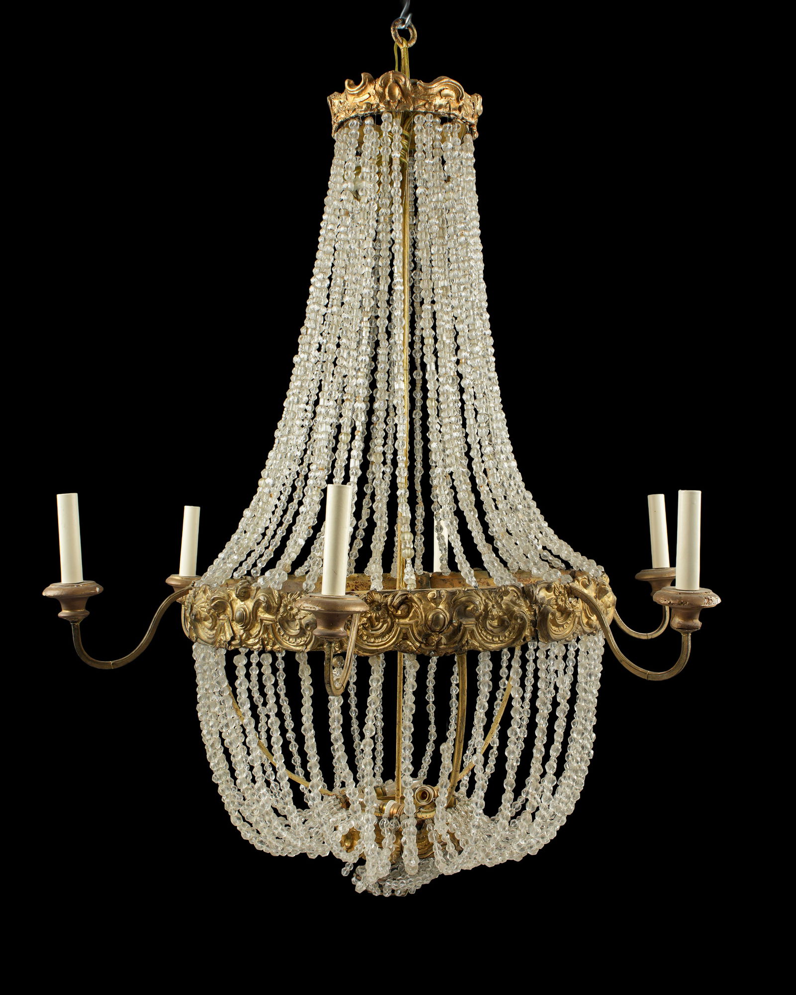 Large French Empire Style Brass Crystal Chandelier: Large late 19th - early 20th Century, embossed brass frames with faceted crystal garland strands. Six scroll arms, overall 40" x 33". Condition: Breaks and repairs to brass, several garland strands se