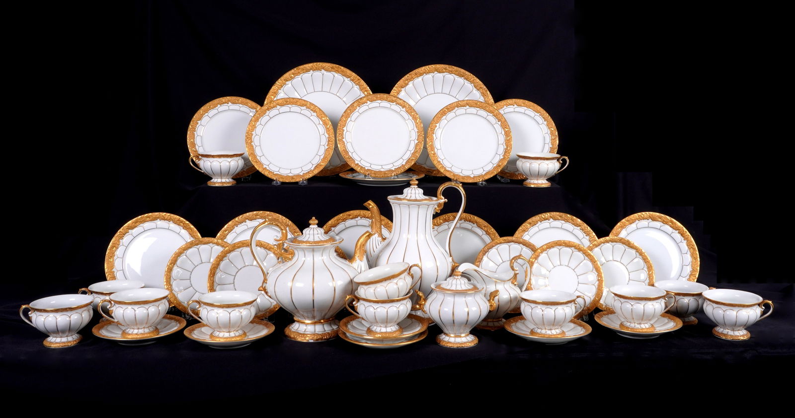 42 piece Meissen Golden Baroque China Service: Approx. 42 pieces in the "Golden Baroque" pattern by Meissen to include 12 plates (7.75" dia., note 2 with chips), 12 footed cups (2.75" h. ), 12 saucers (6" dia), 2 serving bowls (10.75" dia), coffee
