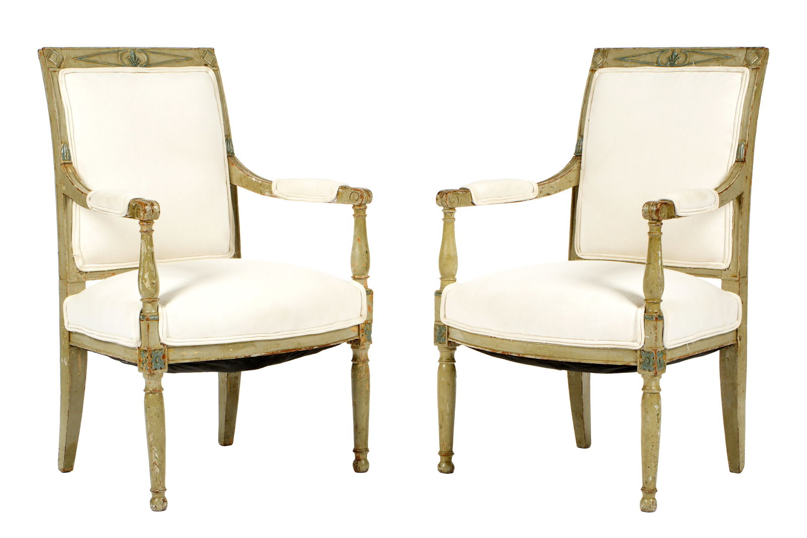 Pair French Carved & Painted Directoire Fauteuils: Carved and painted frames, shaped back and arms, shaped skirt over turned front legs. White canvas upholstery. Overall 35.5" h. x 22.5" x 22". Seat height 17". Condition: Chips and wear to paint decor