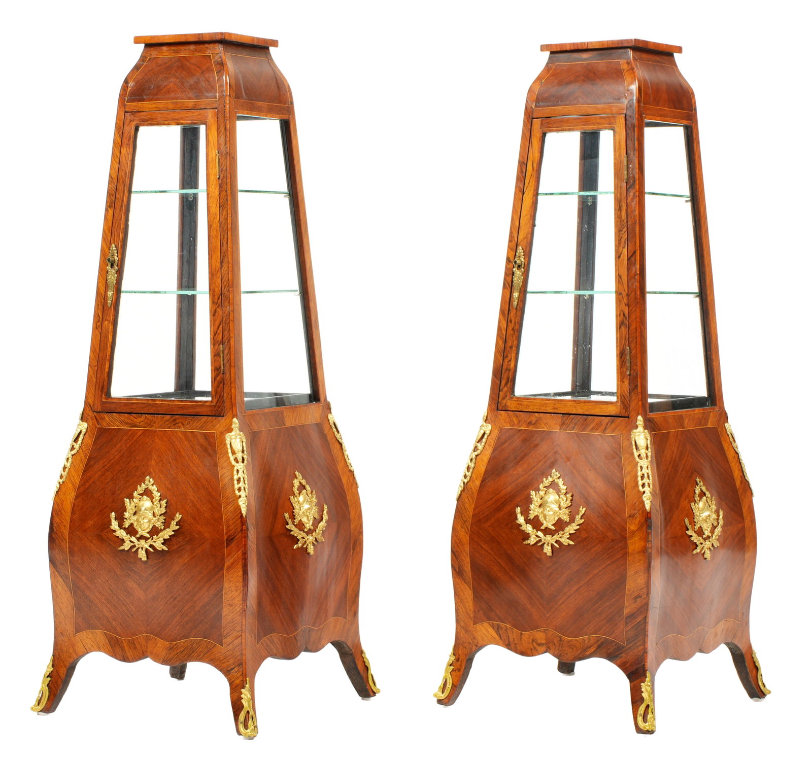 Pair French Empire Style Rosewood Obelisk Vitrines: Banded rosewood and mahogany inlaid square tops over four tapered glass windows, open interior with felt pad. Bombe shaped base with applied gilt metal decoration and accents, shaped skirt and feet. O