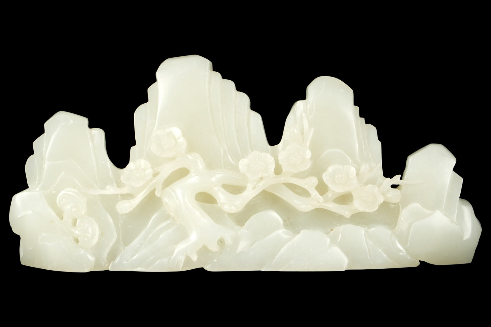 Chinese Natural White Nephrite Jade Brush Rest: 19th Century superlative white jade brush rest with prunus and mountain landscape. Stone with consistent white color. 3" h. x 6.75" x 1.5". Approx. 541 grams.