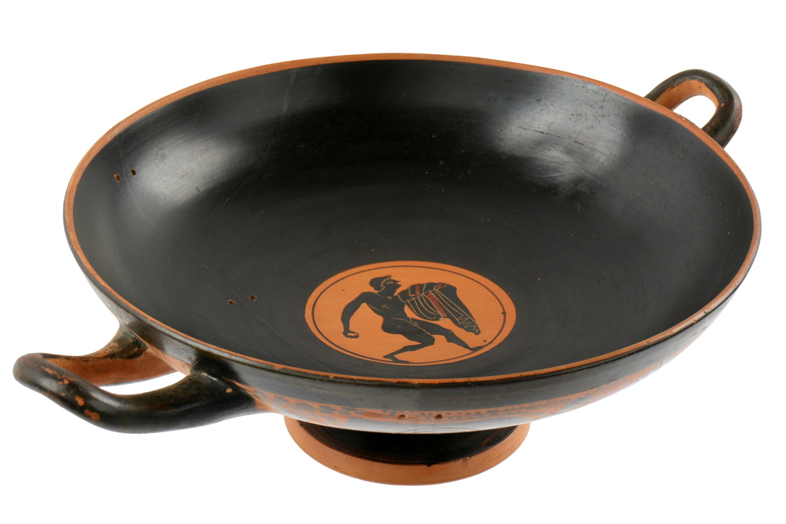 Attic Black Figure Eye Cup Kylix: circa 6th Century BC, attributed to Exkias Potter and painter. A hoplite with shield located between the eyes either side, Tendrils of ivy on red band reserves. Interior medallion depicting right
