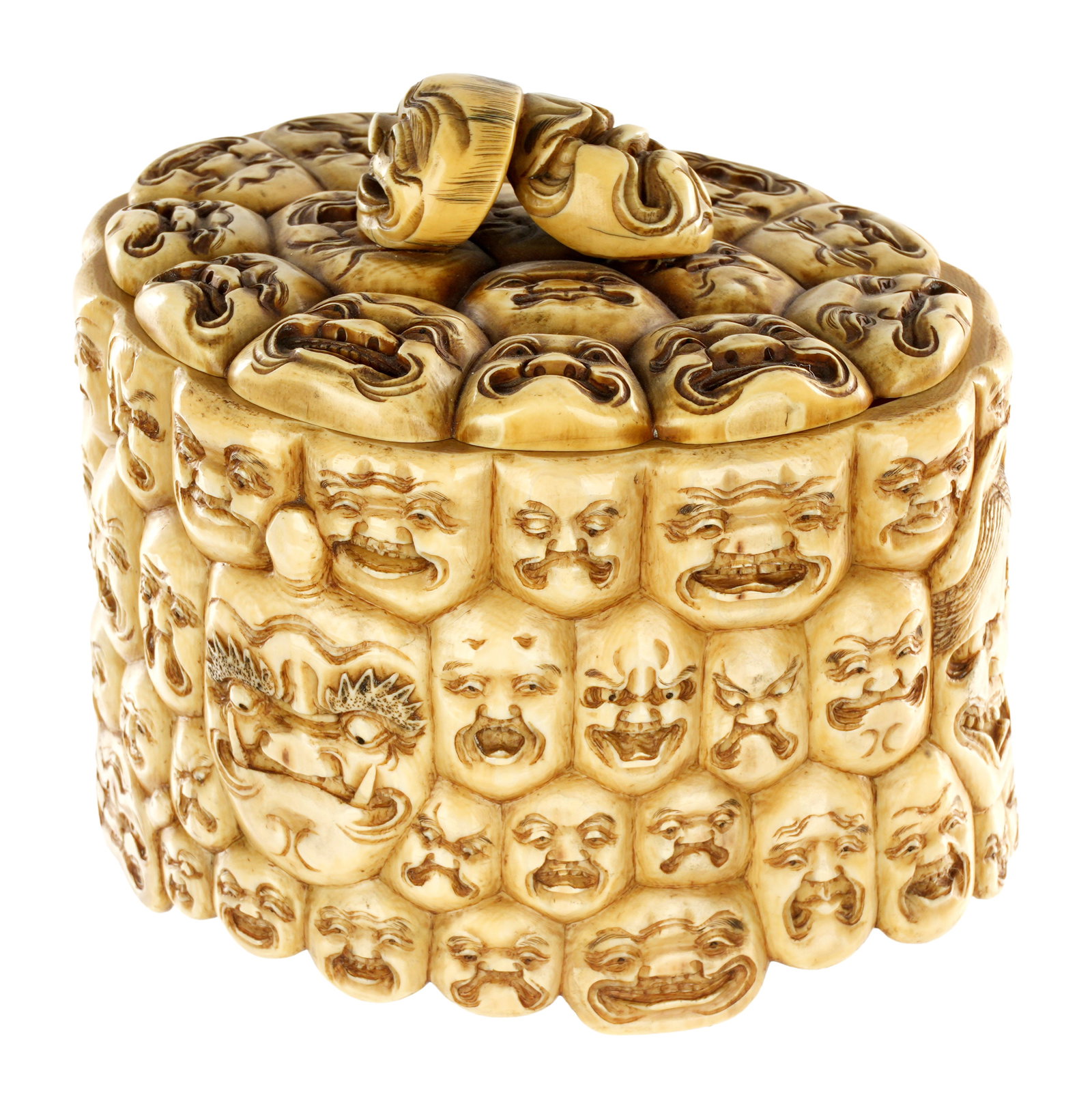 Antique Japanese Carved Bone Noh Trinket Box: Large Meiji carved bone lidded trinket box, profusely carved all over with Noh theater masks, base with carved mask. Marked on base, overall 4.75" h. x 5.5" x 4.25". This lot can not be shipped out of