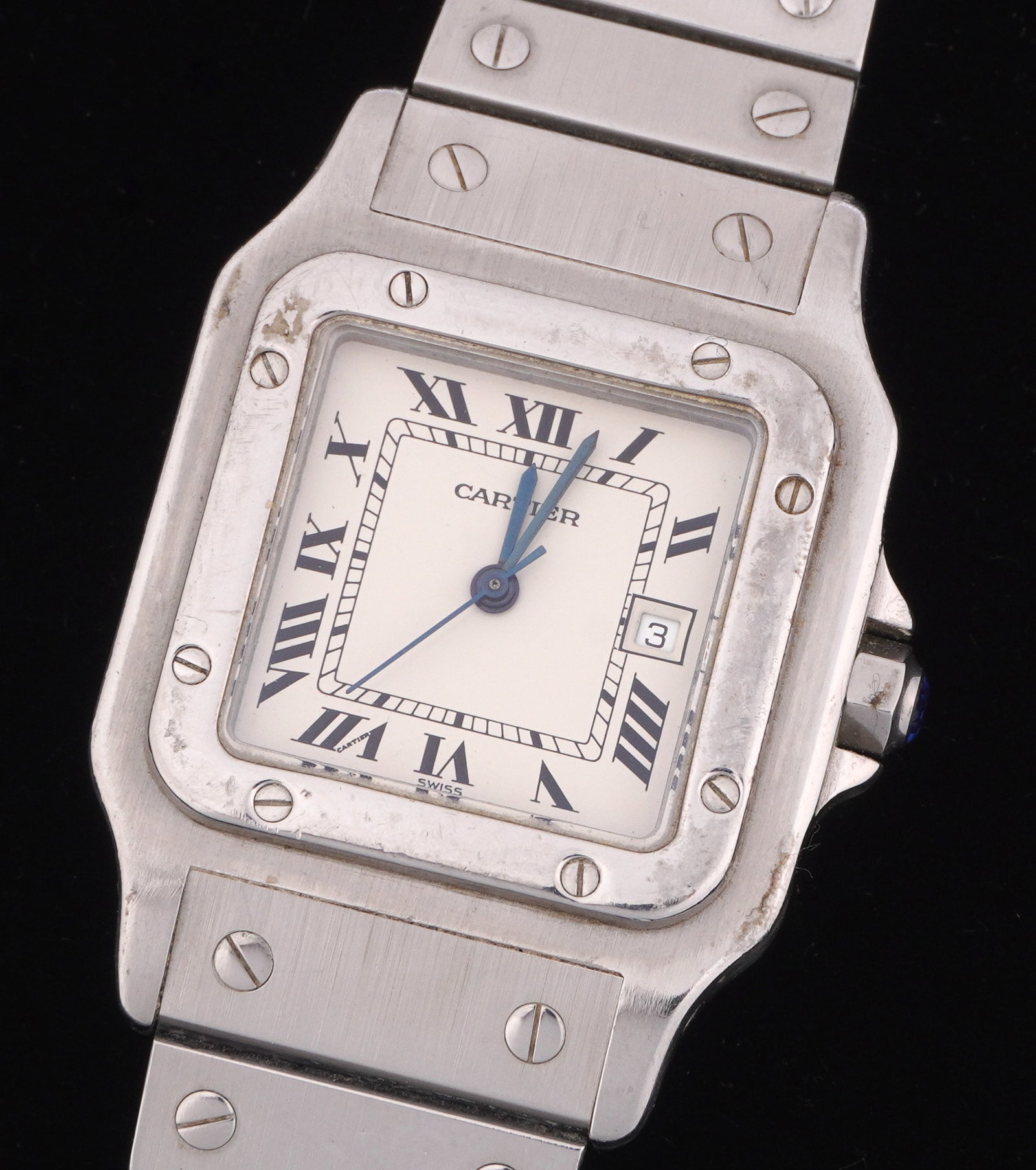 Cartier Santos Stainless Steel Mens Wrist Watch: 29 mm x 29mm stainless steel Santos Tank case, white dial with Roman numerals, secondary date dial, model 296002662, automatic movement 5915. Stainless steel bracelet, 7.5". Sold with original Cartier