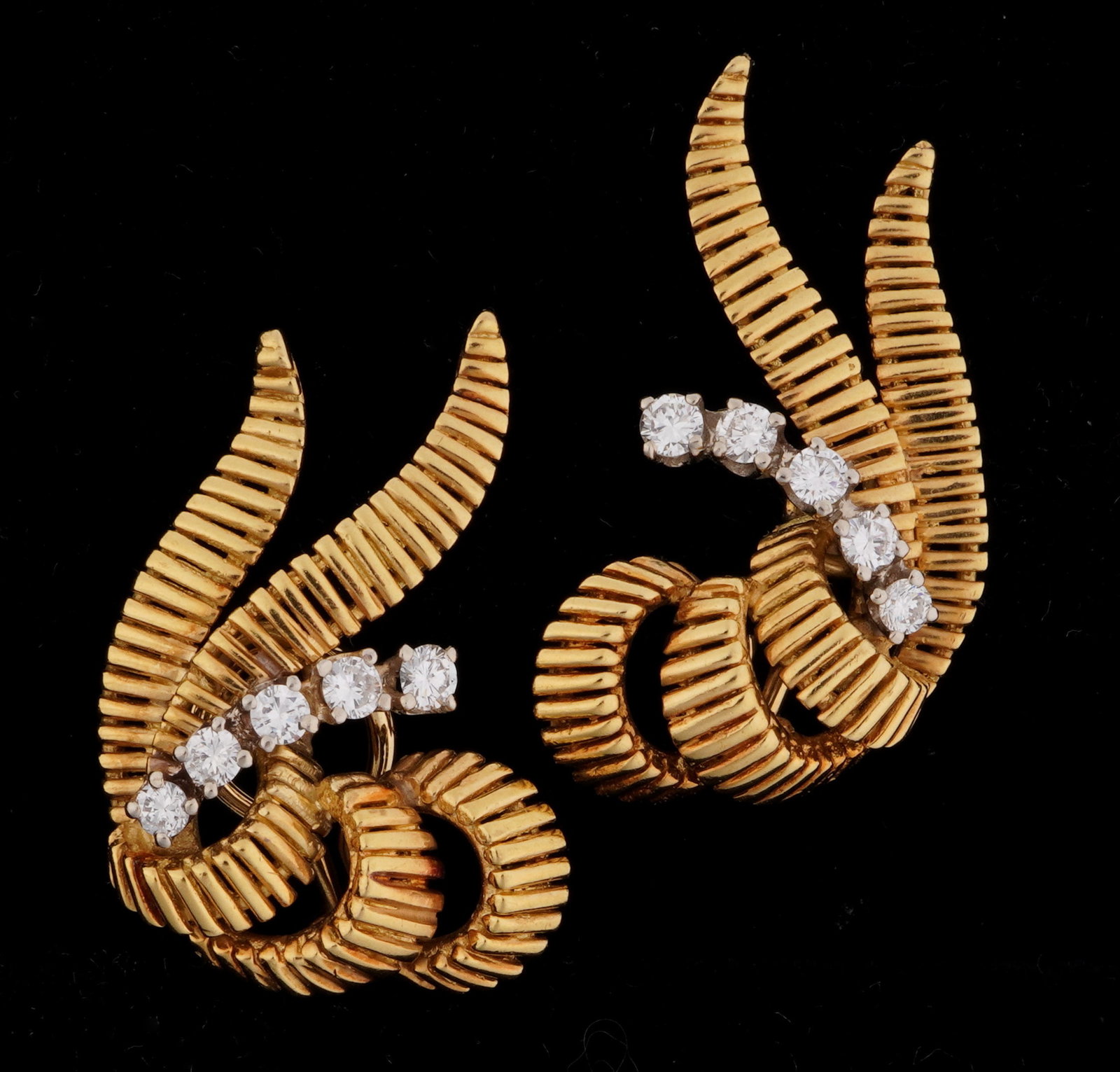 Pair 14k Gold and Diamond Swirl Earrings: Pair 14k yellow gold mid century design swirl earrings with French backs, each with five prong set round diamonds, approx .30ctw. Overall 1.25" x .75". Approx. 11.5 grams inclusive