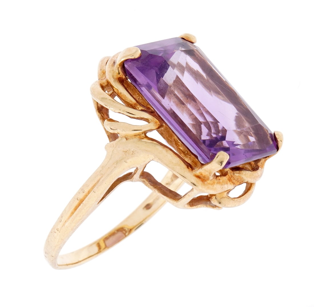 10k Gold and Amethyst Cocktail Ring: Stamped 10k yellow gold and unknown makers mark band. Prong set rectangular faceted amethyst 17mm x 13mm x 5mm. Size 7. Approx. 6.0 grams inclusive.