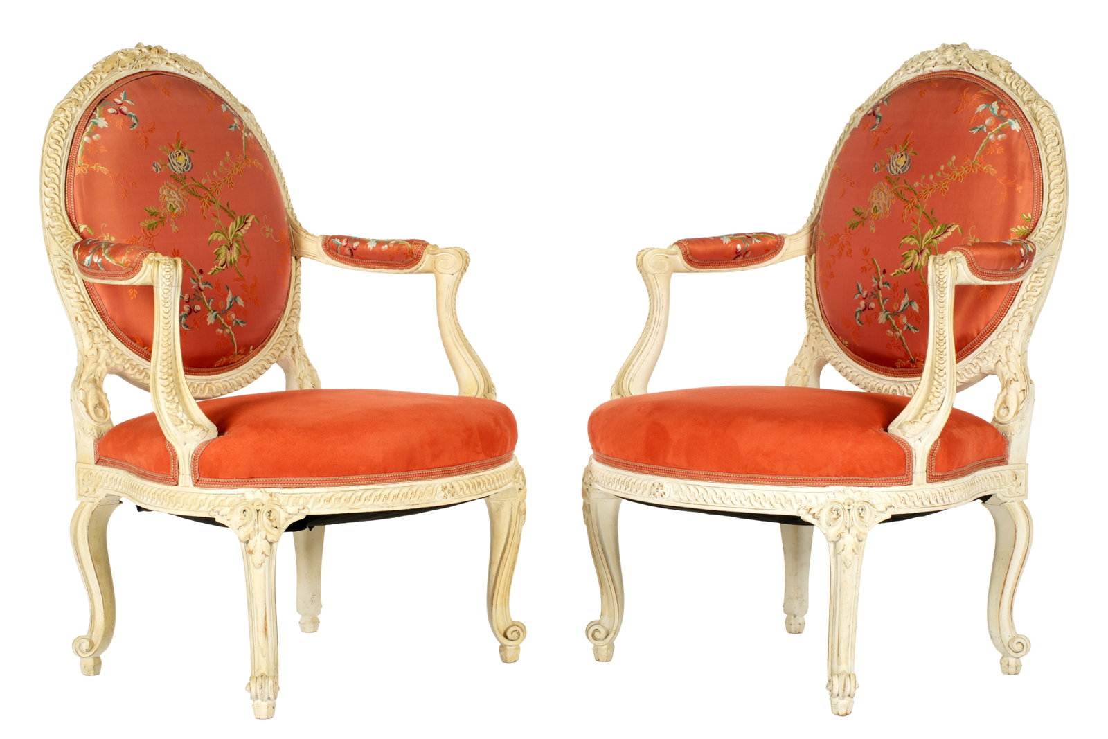 Pair French Louis XVI Style carved Fauteuil Chairs: Carved and painted frames, medallion backs, shaped arms, matching carved aprons, cabriole scroll legs. Floral silk embroidered backs and arm rests, micro fiber seats. Overall 39.25" h. x 24.5" x 24.5"