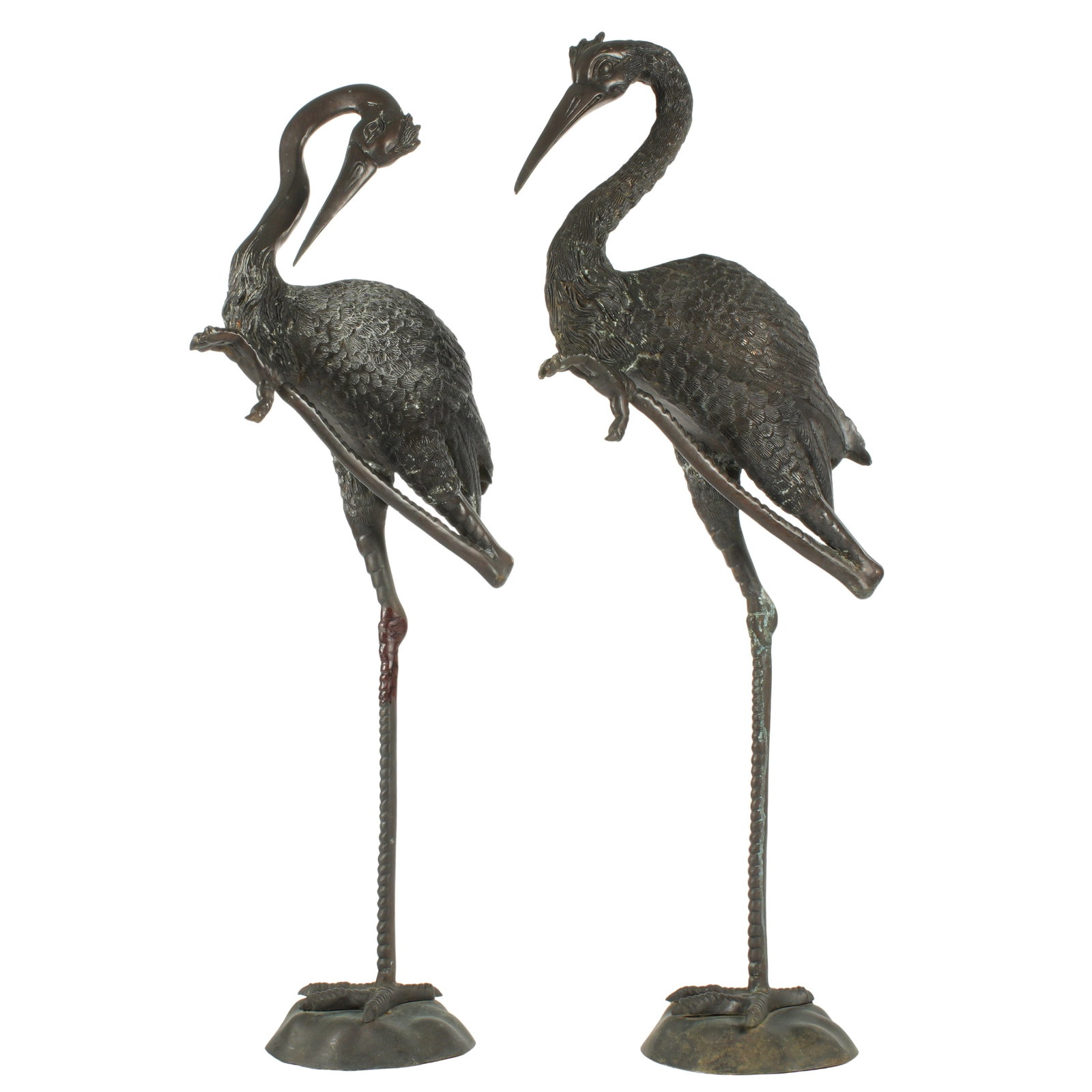 Pair Tall Bronze Garden Cranes Sculptures: Pair patinated bronze figures of cranes or storks, each standing on one leg, no visible markings. Overall 55" h. x 20.5" x 11". Condition: Minor signs of weathering.