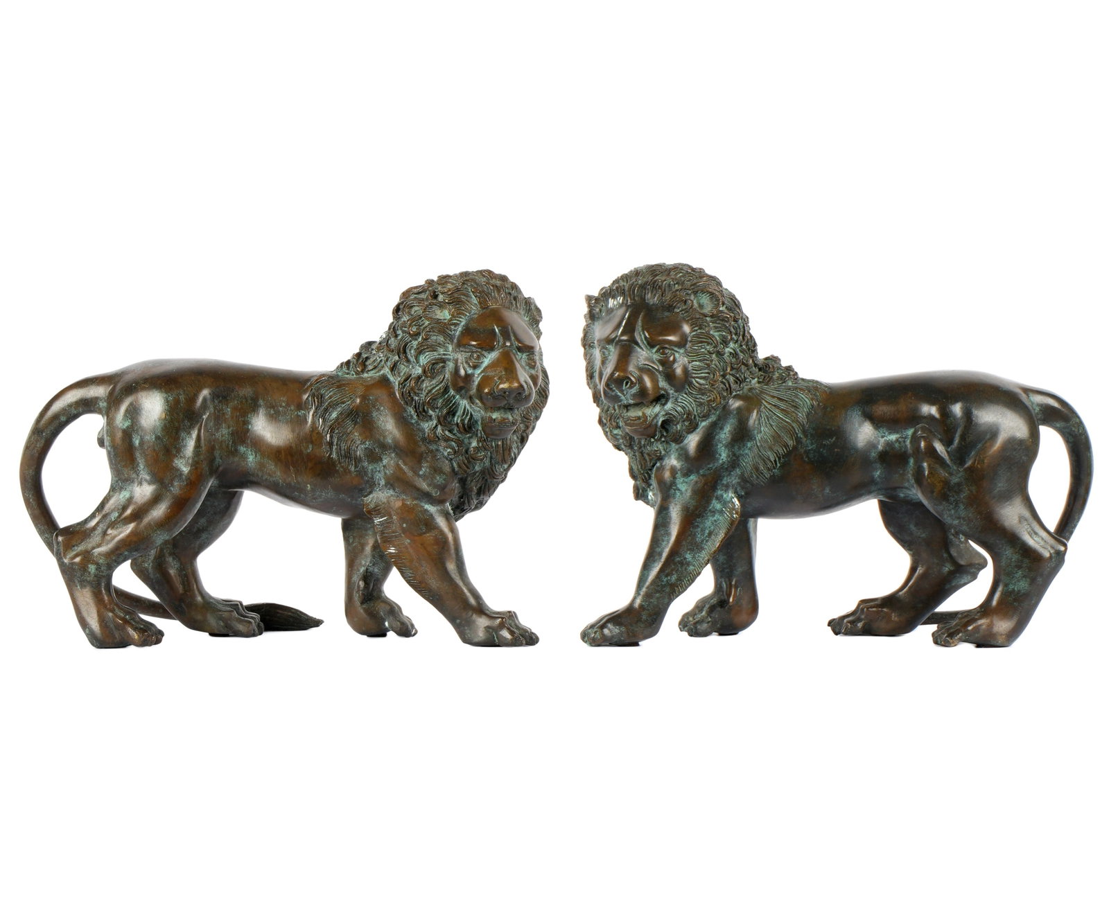 Pair Continental Bronze Diminutive Lions: Mirror image pair patinated bronze standing lions, no visible signature or markings, overall 9" h. x 12.5" x 4.5". Condition: Verdigris, uneven patina.