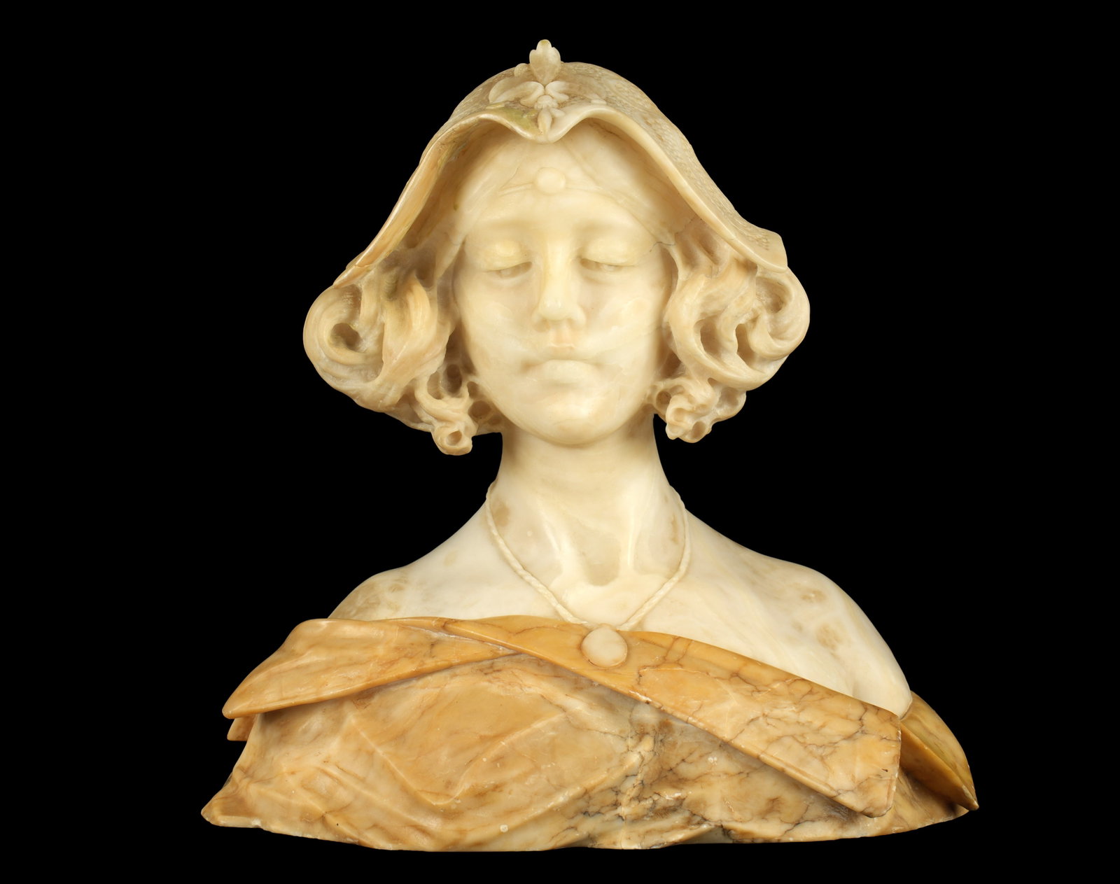 Italian Carved Alabaster Bust of a Maiden: Carved alabaster bust of a young maiden with lace headwear, pendant on necklace, no visible signature. Overall measures 16" h. x 15" x 9". Condition: Minor chips and abrasions.
