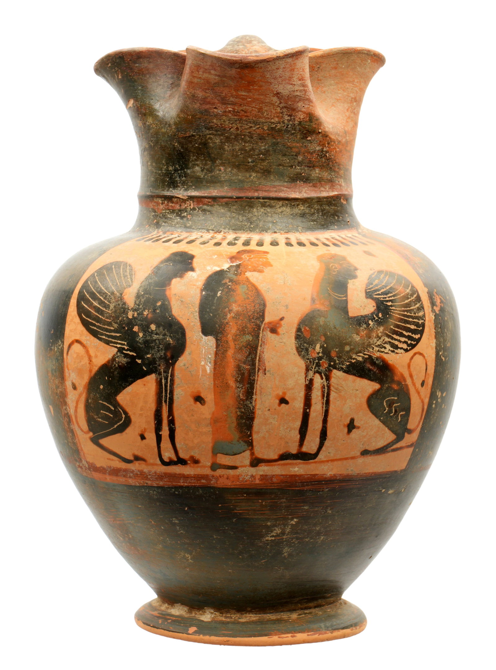 Attic Black Figure Oinochoe with Sphinxes: circa 5th Century BC, trefoil rim, decorated in reserve with standing elder figure flanked on either side by sphinxes, overall 8.5" h. x 6". Provenance: Private collection in Sarasota, purchased at