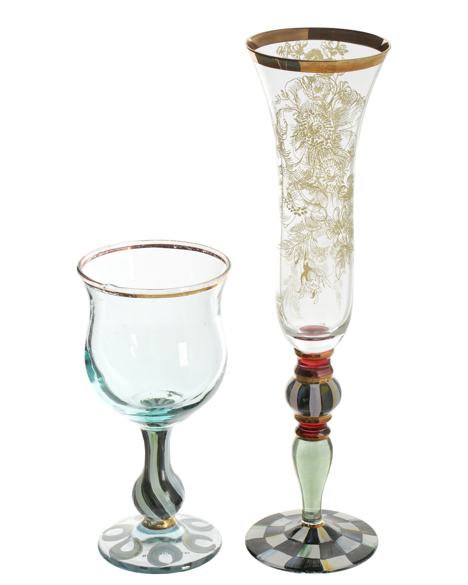 Two MacKenzie-Childs Painted Crystal Stemware: Two pieces total to include 1) Champagne flute in the Blooming pattern, gilt rim, gilt floral motif body. Painted and colored glass stem and foot. 11.25" h. 2) Unknown pattern wine glass, gilt rim,