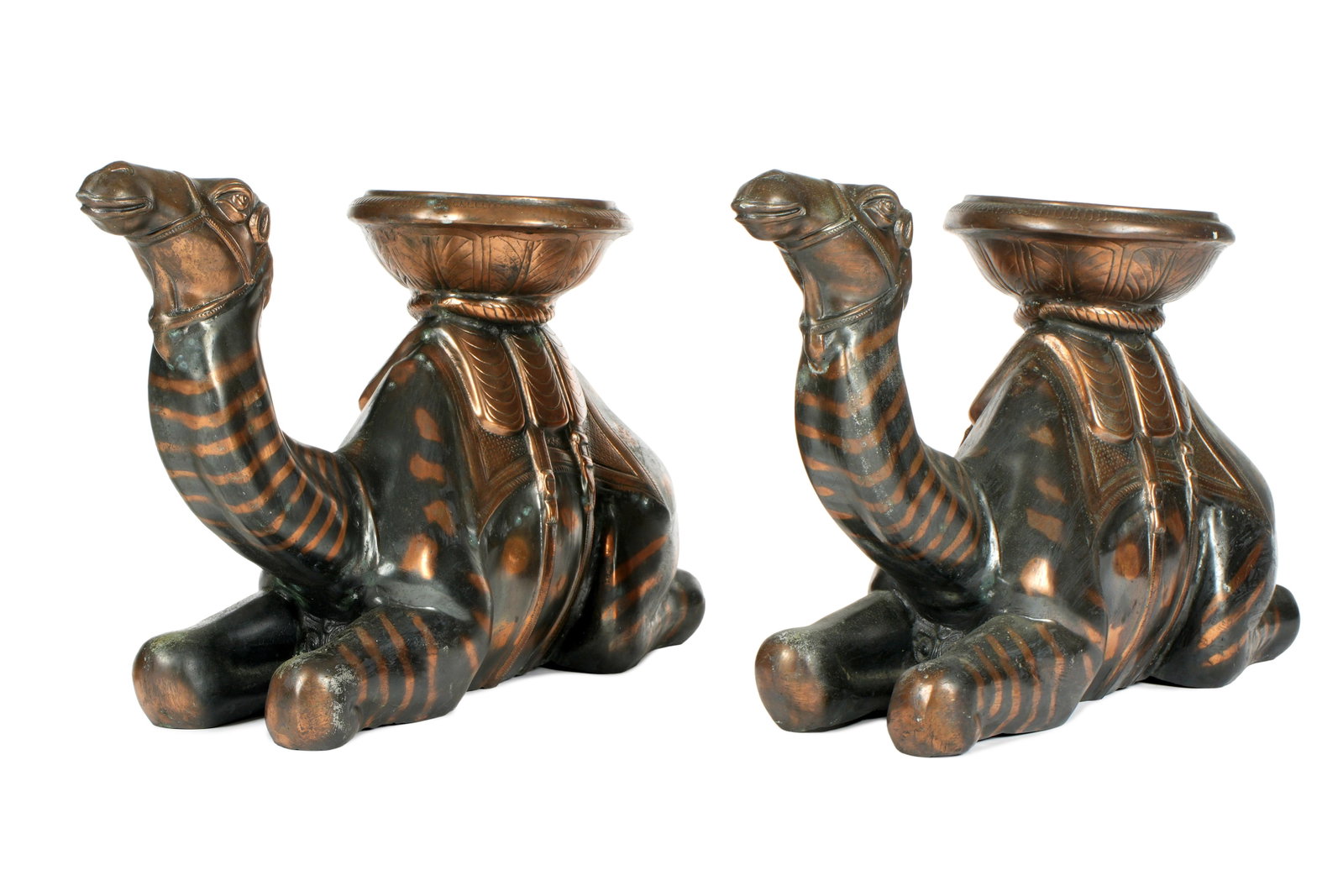 Pair Large Patinated Metal Figures of Camels: Pair patinated metal, possibly copper, figures of kneeling camels with embossed tray on top. May have been used as side table bases. No visible markings, overall 17.5" h .x 33" x 8.5". Condition: Unev