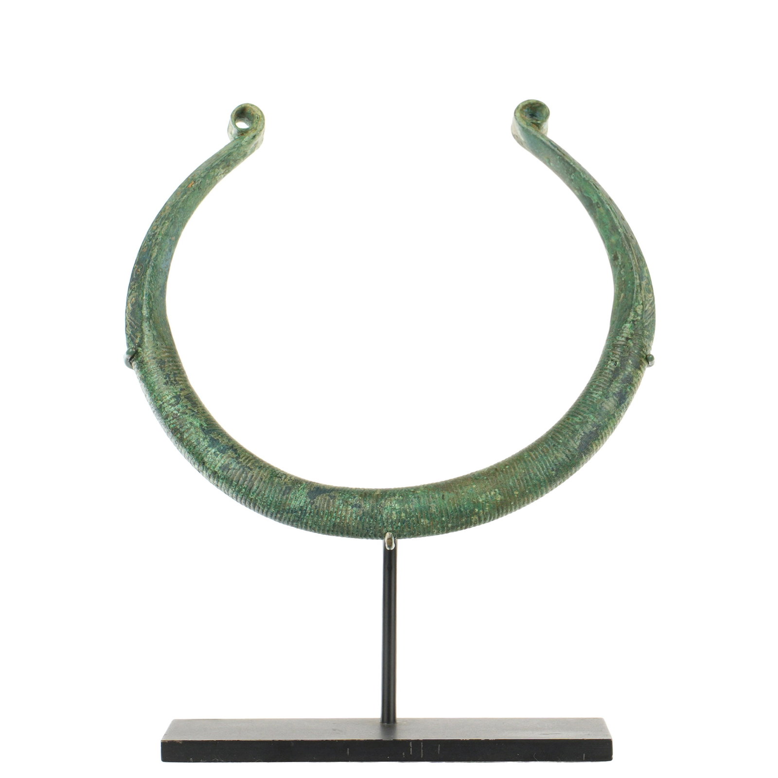 Greek Geometric Bronze Incised Torque Neck Ring: Eastern Mediterranean, circa 9th -7th Century BC, bronze toque (torc) neck ring with incised geometric designs, 5.25" x 6". Provenance: Private Collection in Sarasota, purchased at Arte Primitivo auct