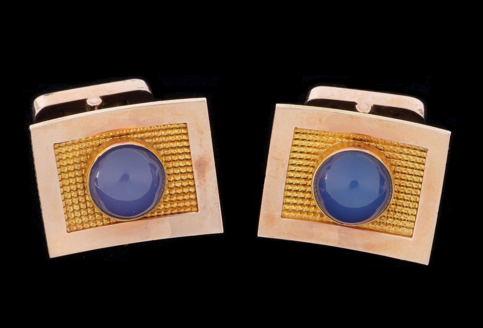 Pair 14k Gold and Moonstone Cufflinks: Pair stamped 14k yellow gold cufflinks with shaped tops, each with blue moonstone cabochons, approx 8mm dia. Tops 375" x .5". Approx. 12.5 grams inclusive.