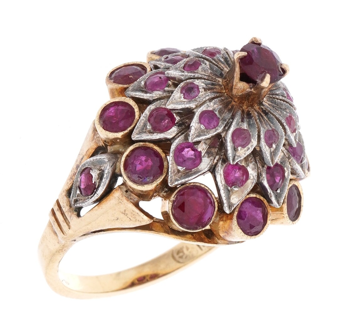 14k Gold and Ruby Cluster Cocktail Ring: Stamped 14k white and yellow gold floriform cluster band, center raised prong set round ruby, approx. 31 prong and cabochon set accent rubies. Size 5.5. Approx. 8.7 grams inclusive.