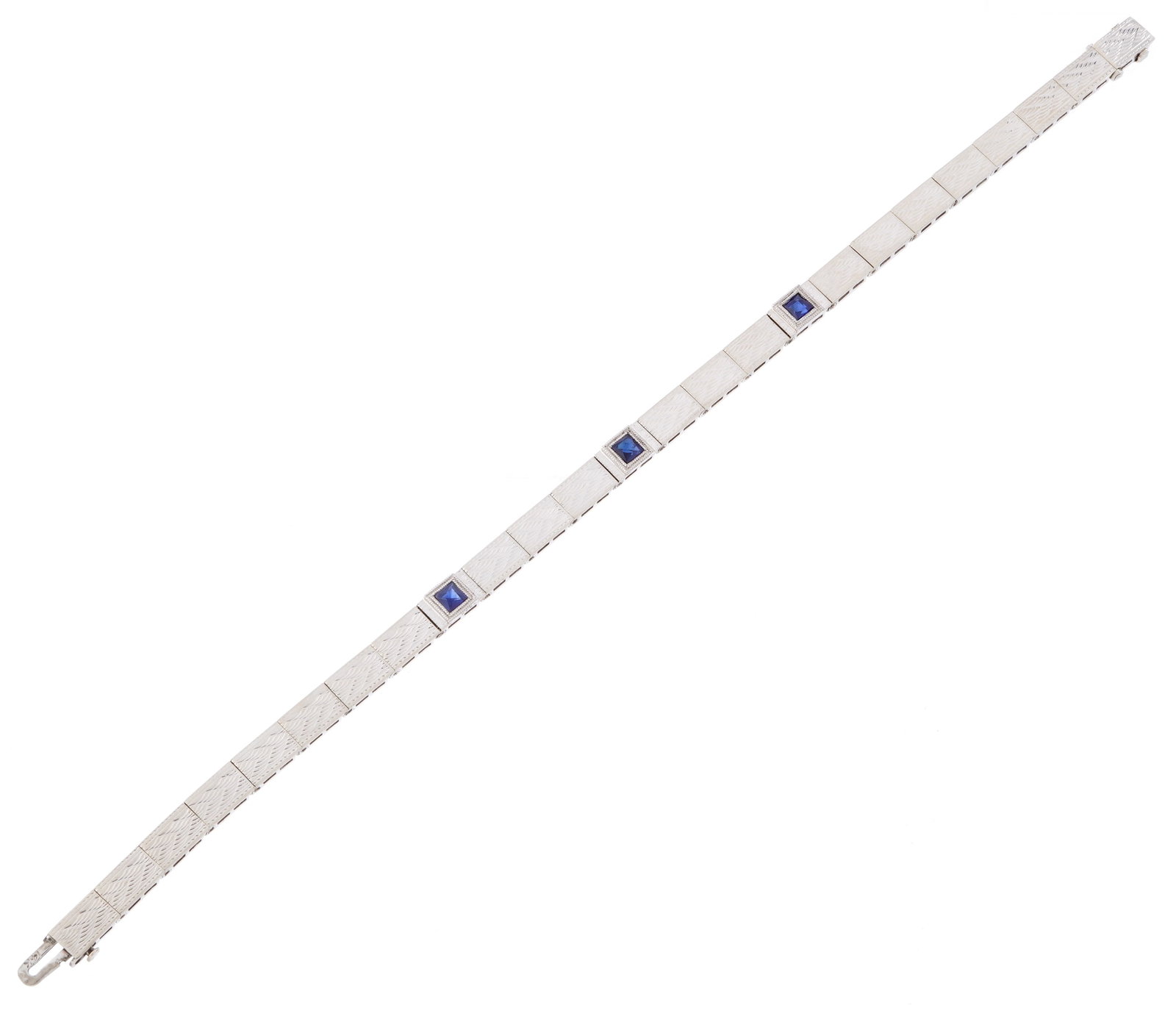 14k White Gold and Sapphire Art Deco Bracelet: Stamped 14k white gold art deco design link bracelet with etched geometric patterns on links, three small bezel set square accent sapphires, each approx. 4mm x 4mm. Overall 7" long. Approx. 8.5 grams 