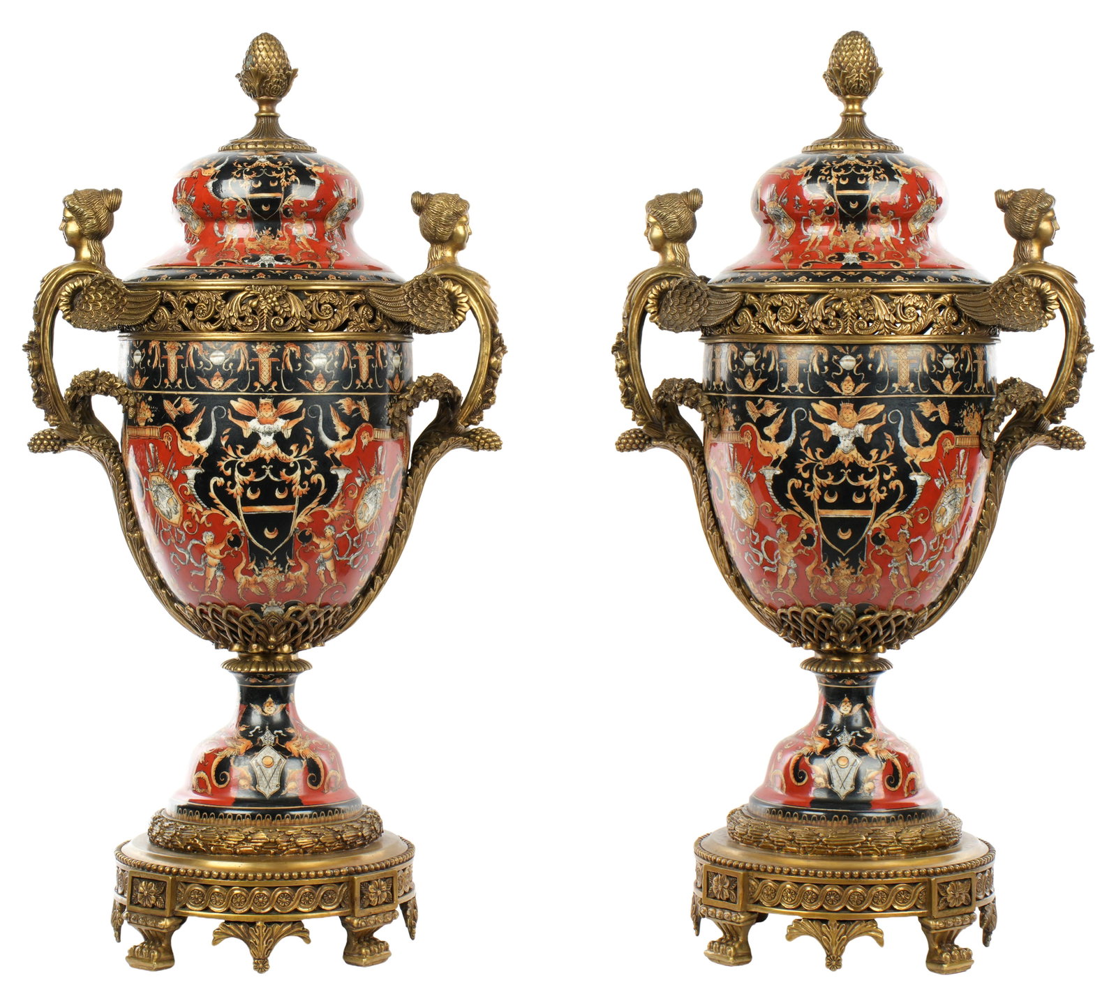 Pair Neoclassical Bronze Mounted Covered Urns: Pair United Wilson Porcelain Factory neoclassical design covered urns. Bronze pineapple finial, winged maiden handles, and base. Marked with JUWC 1897 mark on bronze base. Overall 25.5" h. x 13".
