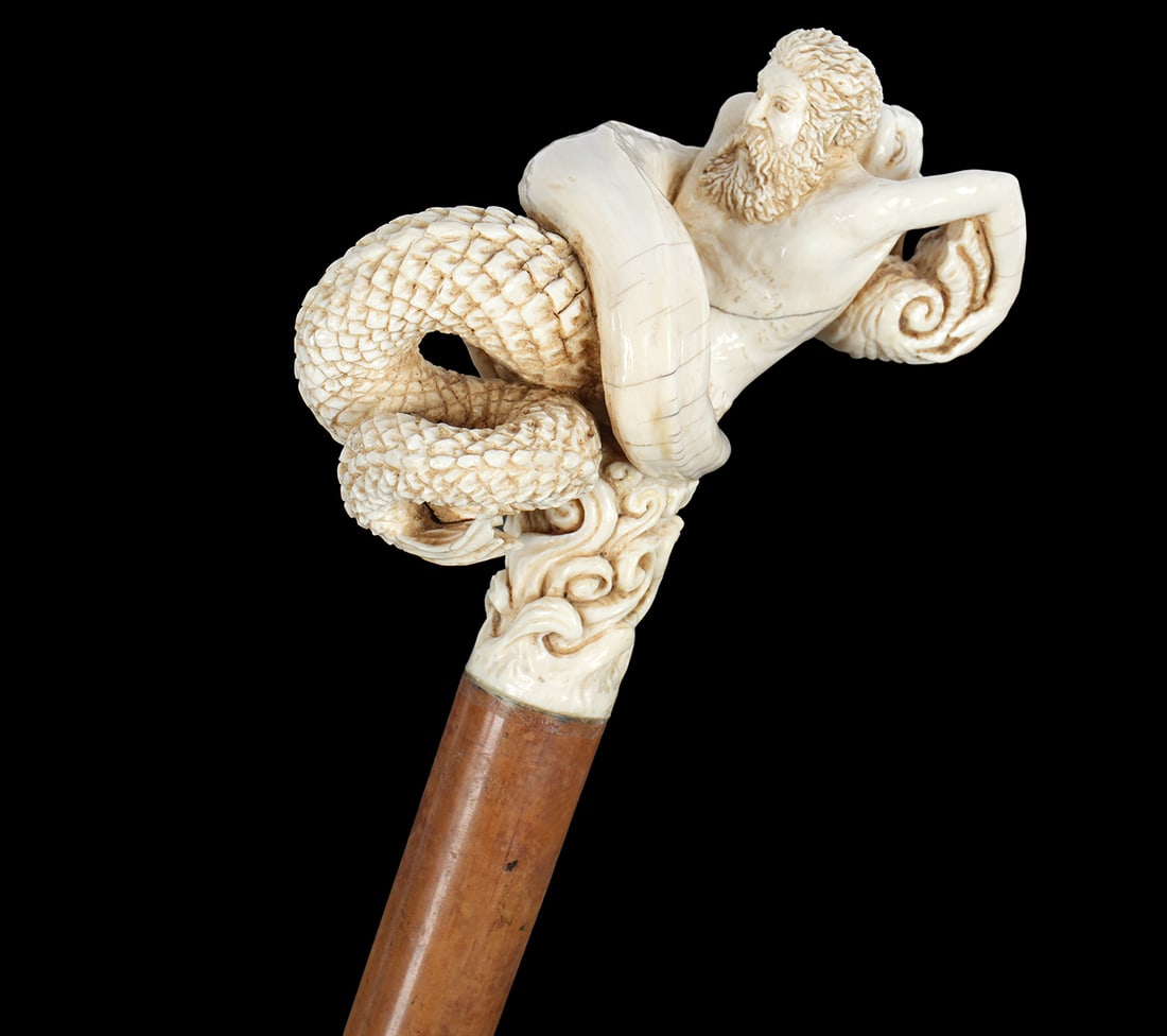 Antique Carved bone Neptune Serpent Walking Stick: Antique walking stick / cane. Carved bone figure of Neptune fighting mythological serpent over waves handle. Wood shaft, bone tip. Overall 38.75" long. THIS LOT CANNOT BE SHIPPED OUTSIDE THE STATE OF 