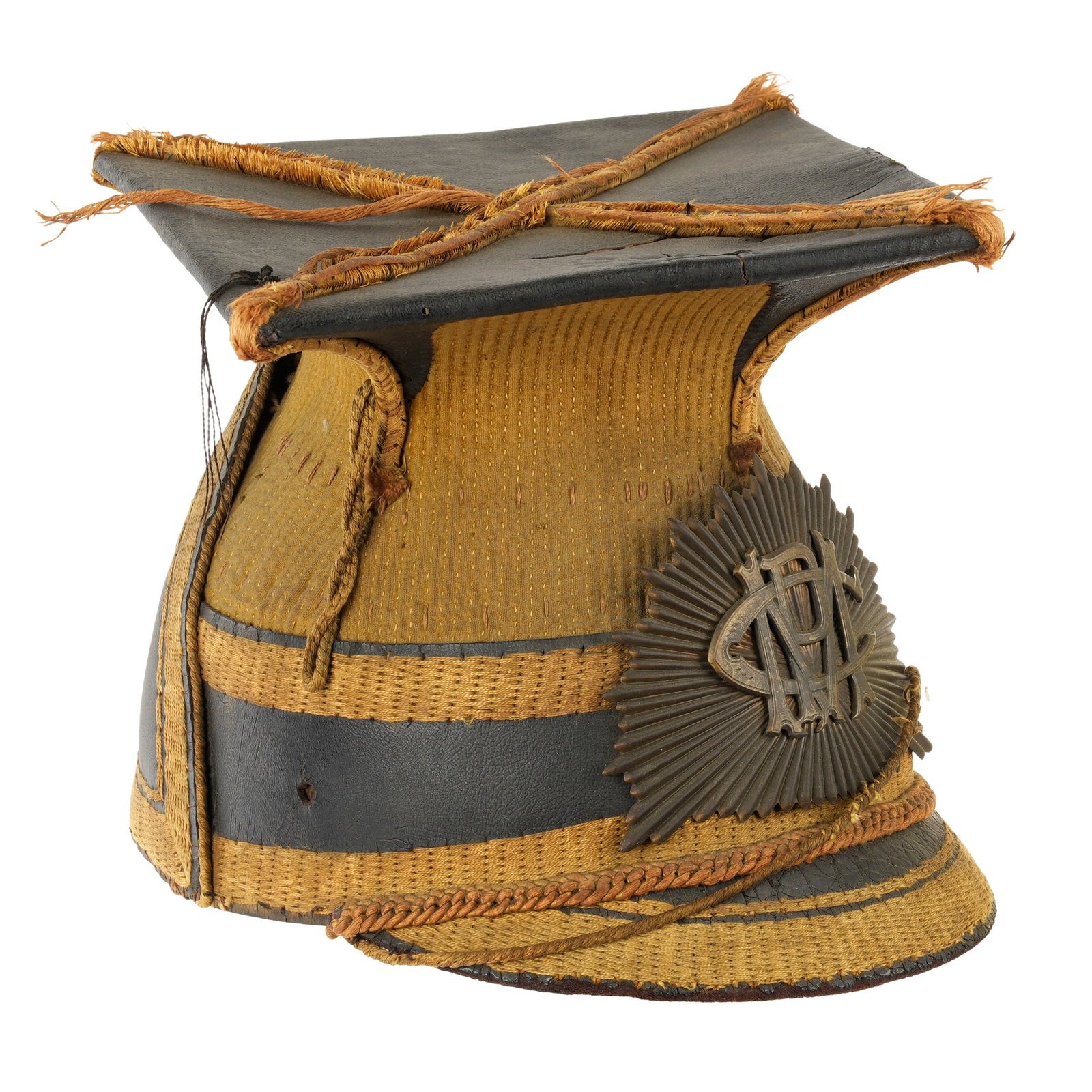 WWI British Officers Czapka / Shako Helmet Cap: WWI era British czapka, leather body, yellow cording, sunburst front badge with monogram CMP. Overall measures 7" h. x 10" x 10". Condition: In need of conservation. Please see photos.