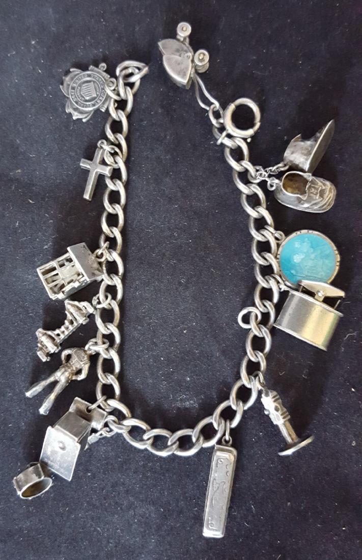 silver charm bracelet: 1970s 80s sterling silver 14 charms 7" long