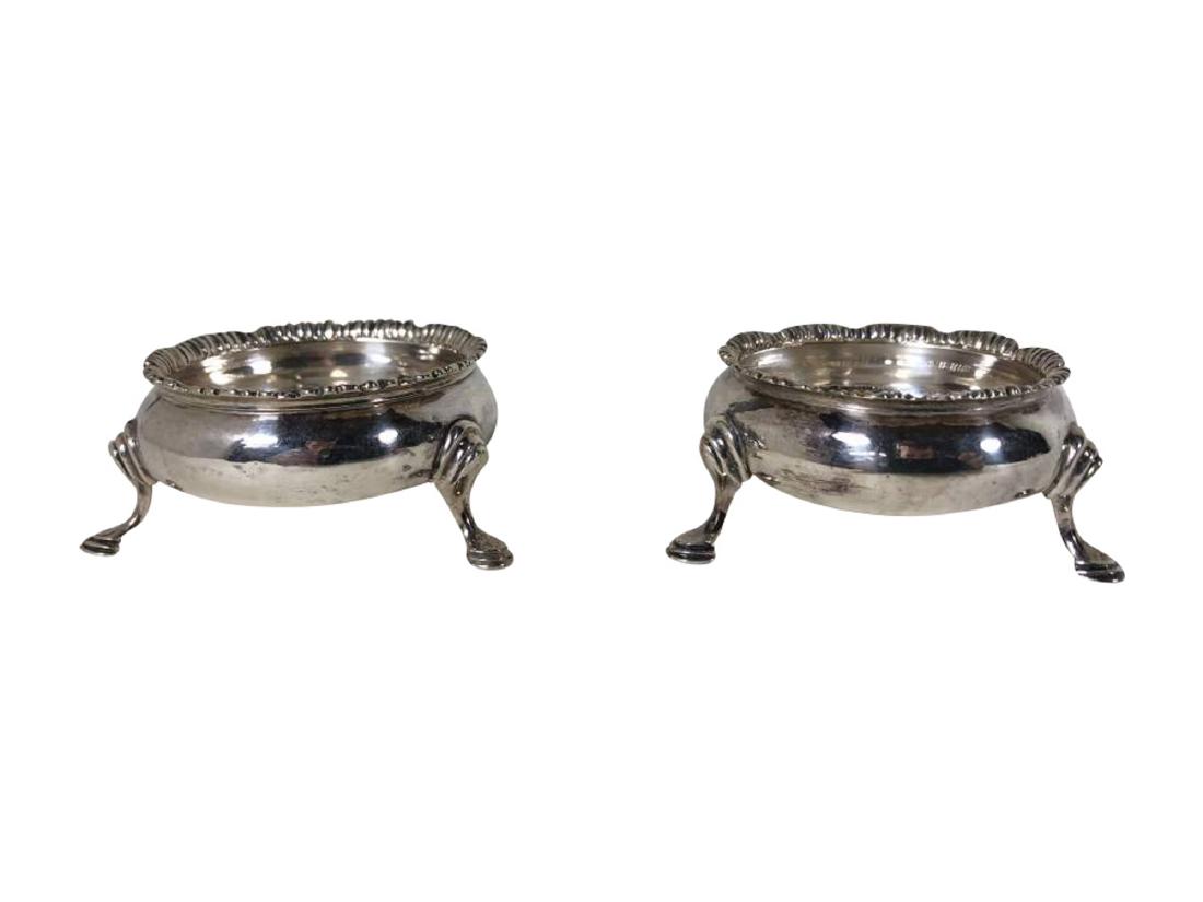 Pair of George III Sterling Silver Open Salt Cauldrons: A pair of sterling silver open salt cauldrons with flared rims and three feet each. Hallmarks on the bottom indicate maker John Munns 1763 London, England. 2.5" in diameter by 1.5" 3.3 t oz