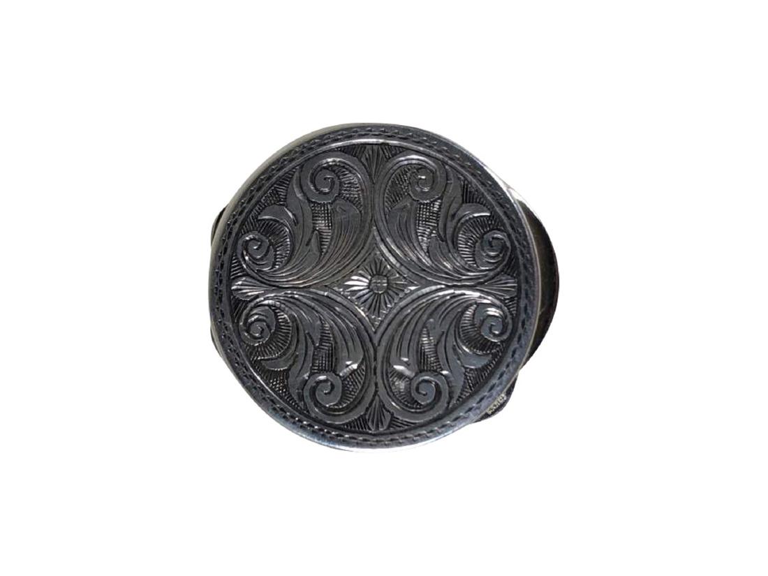 An Engraved Sterling Silver Pill Box from Gucci: A sterling silver pill box from Gucci with an engraved top. Marked "GUCCI" and "925" on the clasp. 1.25" in diameter