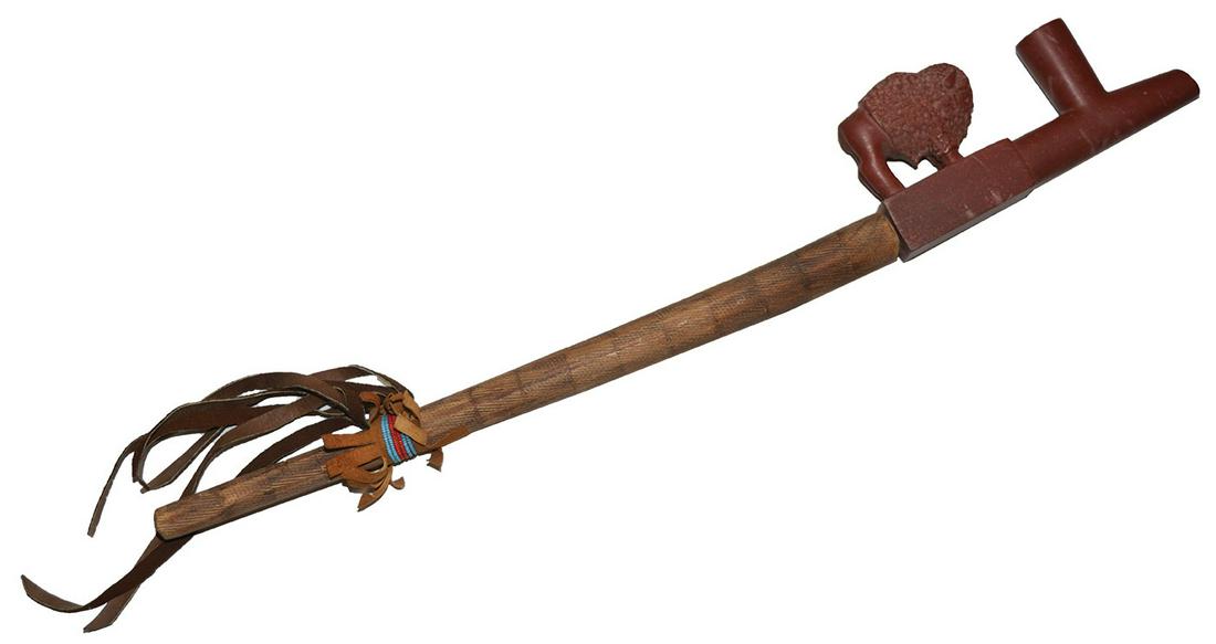 26 1/2" Buffalo Effigy Catlinite Pipe and Carved Wood: 26 1/2" Buffalo Effigy Catlinite Pipe and Carved Wood Stem. 1950's Tourist Trade. Signed by "Standing Eagle". Fine condition. This piece decorated the Roberts (Dale and Betty) relic room for years. Na