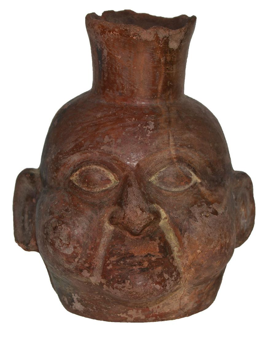 6 1/2" H. Incan Head Pot. Pleasing depiction: 6 1/2" H. Incan Head Pot. South America. Pleasing depiction, nice detail. Red slip paint. Solid, some nicks to rim. Pre-Columbian. Ex-Tommy Bryden