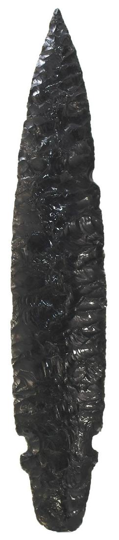 8 7/8" Obsidian Spear. CA. Featured in Modoc Smith's: 8 7/8" Obsidian Spear. Northern CA. Black Obsidian. Back side patinated with light gray film. Thin well made with pronounced parallel flaking. Ex-Charlie (Modoc) Smith (122), Walter Nelson. Featured i