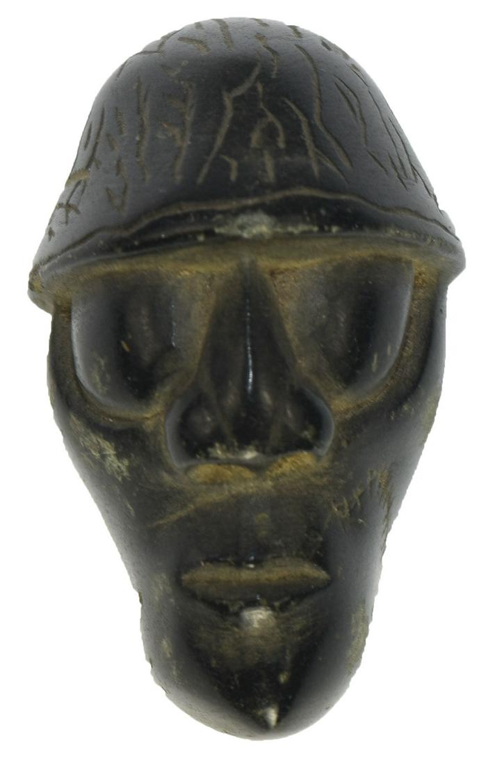 1 7/8" Carved Face. Possibly Taino. Form of polished: 1 7/8" Carved Face. Possibly Taino. Form of polished dark green Jadeite. Excellent condition. Drilled. Ex-Ray Franks