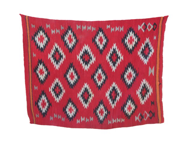 49" x 64" Navajo Rug. Made by a Navajo woman 1910: 49" x 64" Navajo Rug. Made by a Navajo woman in 1910. Ex-Beanie Johnson. No fading, burns or stains. One area apprx 3" in length shows unraveling (see photo). Was folded on a shelf in Duane's artifact