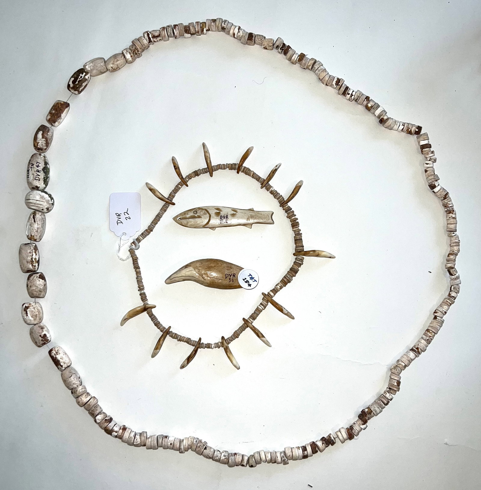 2 Shell Bead necklaces (one with canine teeth), Bear tooth and carved fish effigy. Ex-Dale Rector.: 2 Shell Bead necklaces (one with canine teeth), Bear tooth and carved fish effigy. Largest necklace is from TN, rest are from KY. Ex-Dale Rector.