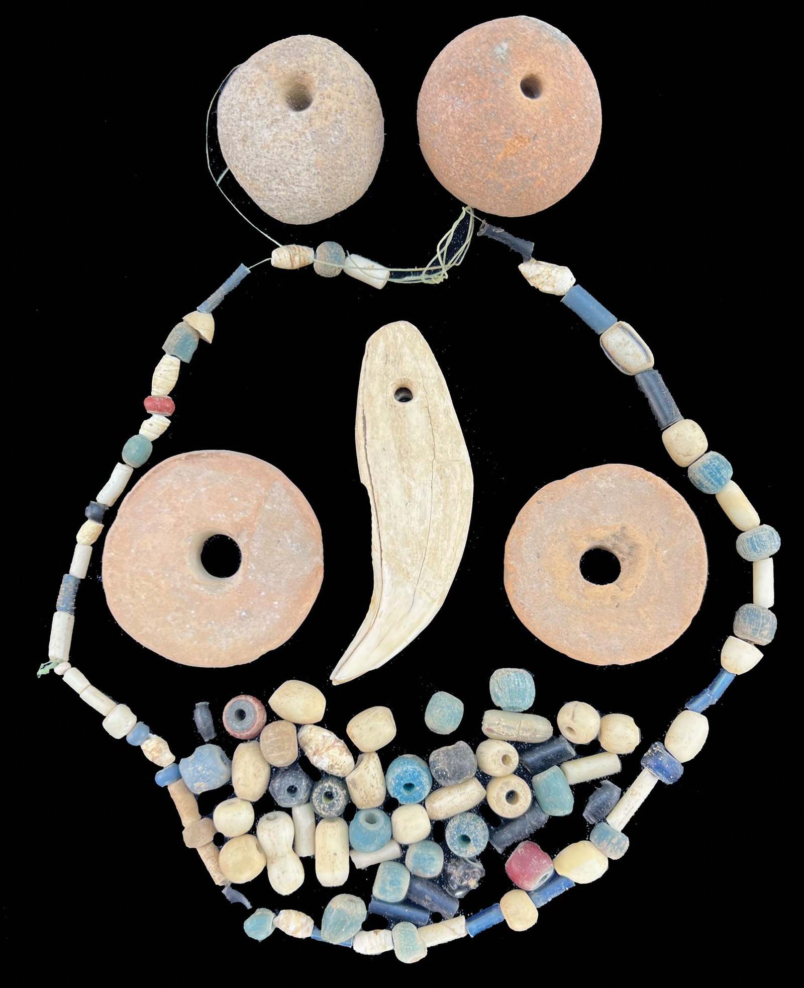 Frame of beads. Recovered by Lloyd and Karin Cash.: Frame of beads. Two disks beads, two round beads, one bear tooth and several small beads. recovered by Lloyd and Karin Cash.