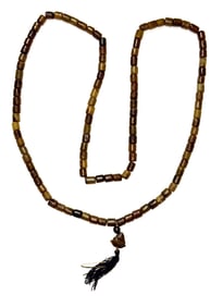 56" Strand of Beads. Shades of amber, green & brown beads with markings. Ex Watkins.